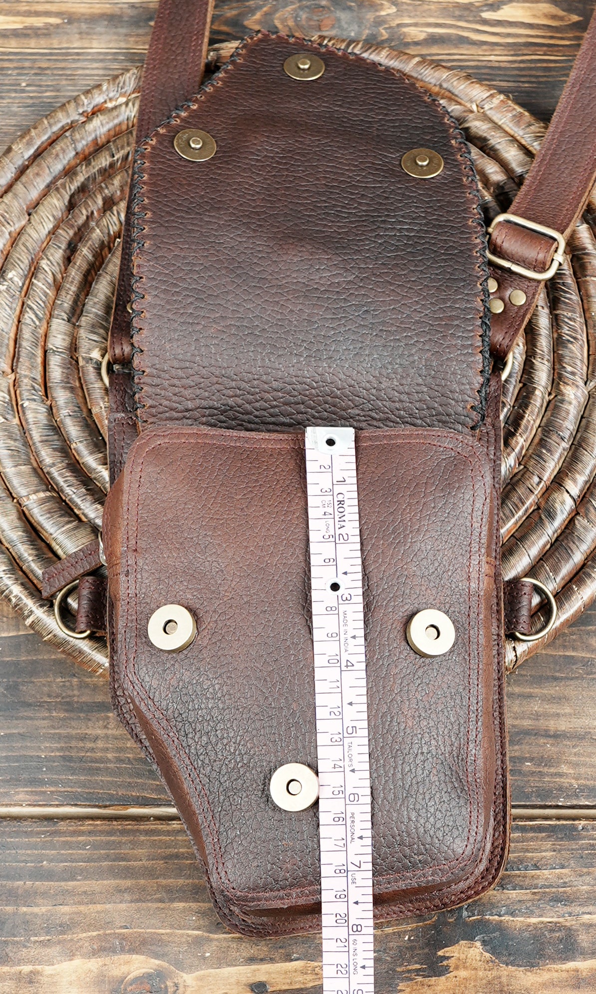 Rustic brown leather harness bag with gemstone accents