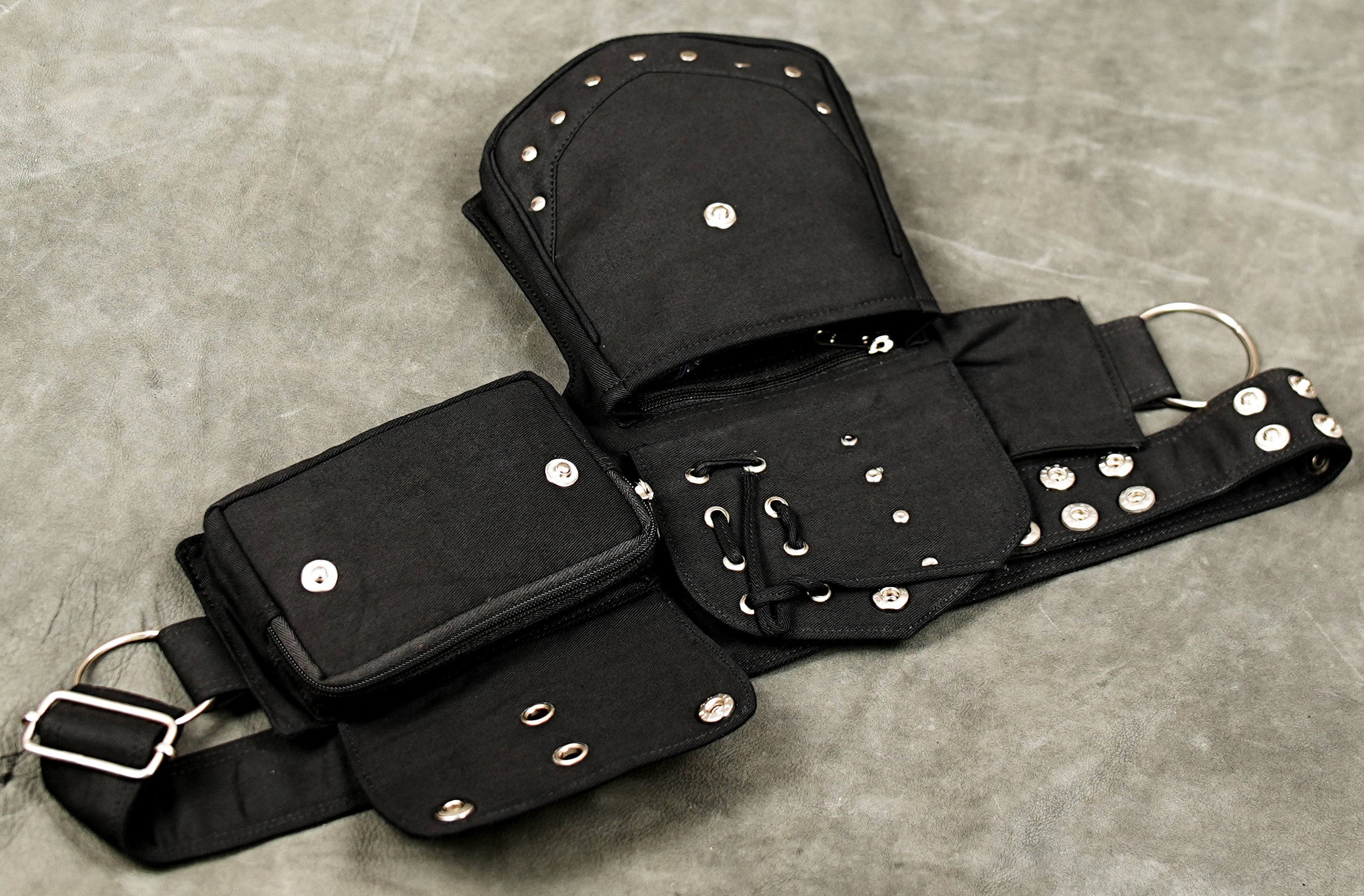 Black cotton hip belt with decorative metal studs and adjustable strap for Burning Man outfits.