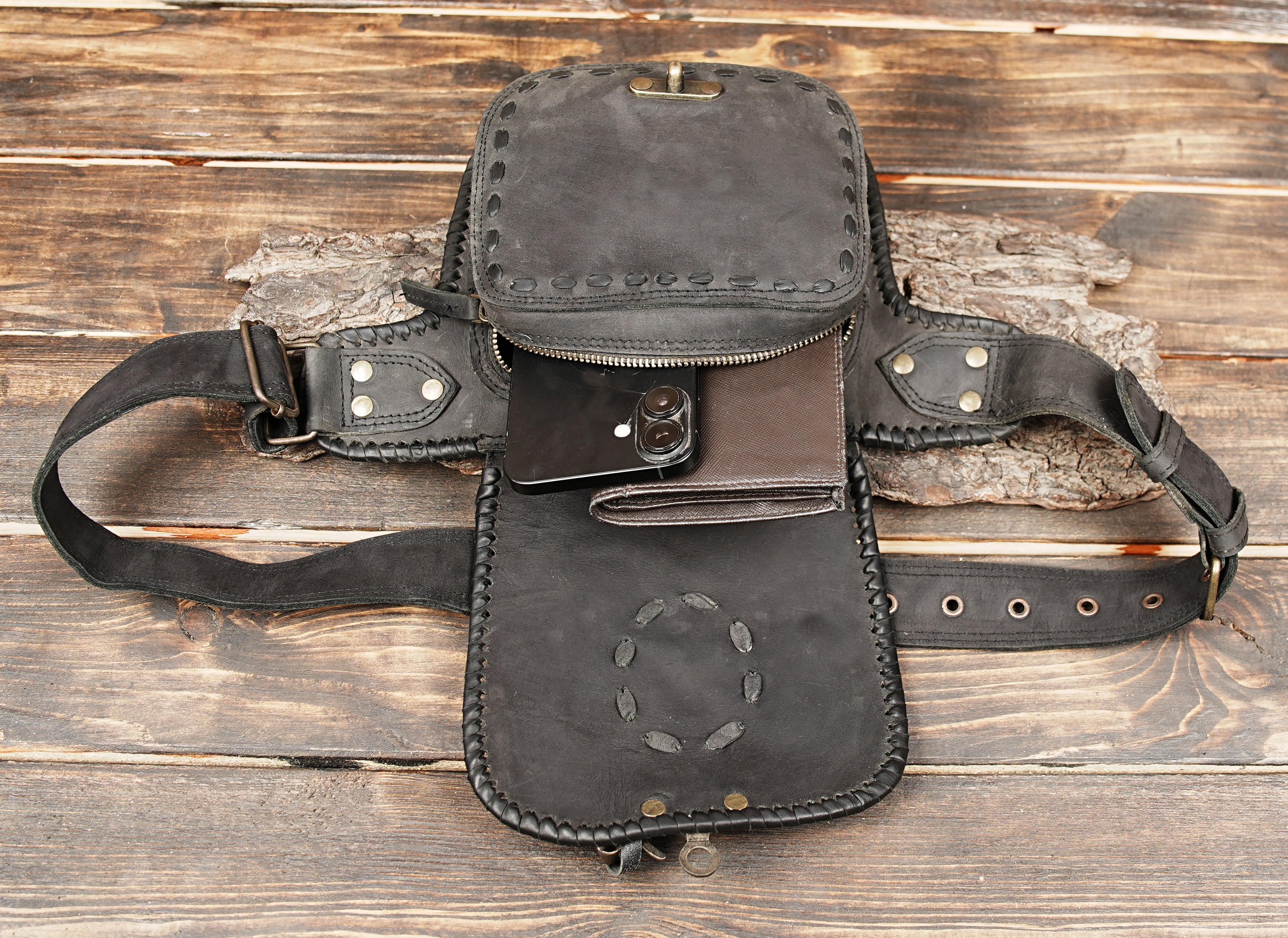 Back view of black leather waist pouch with zipper pocket