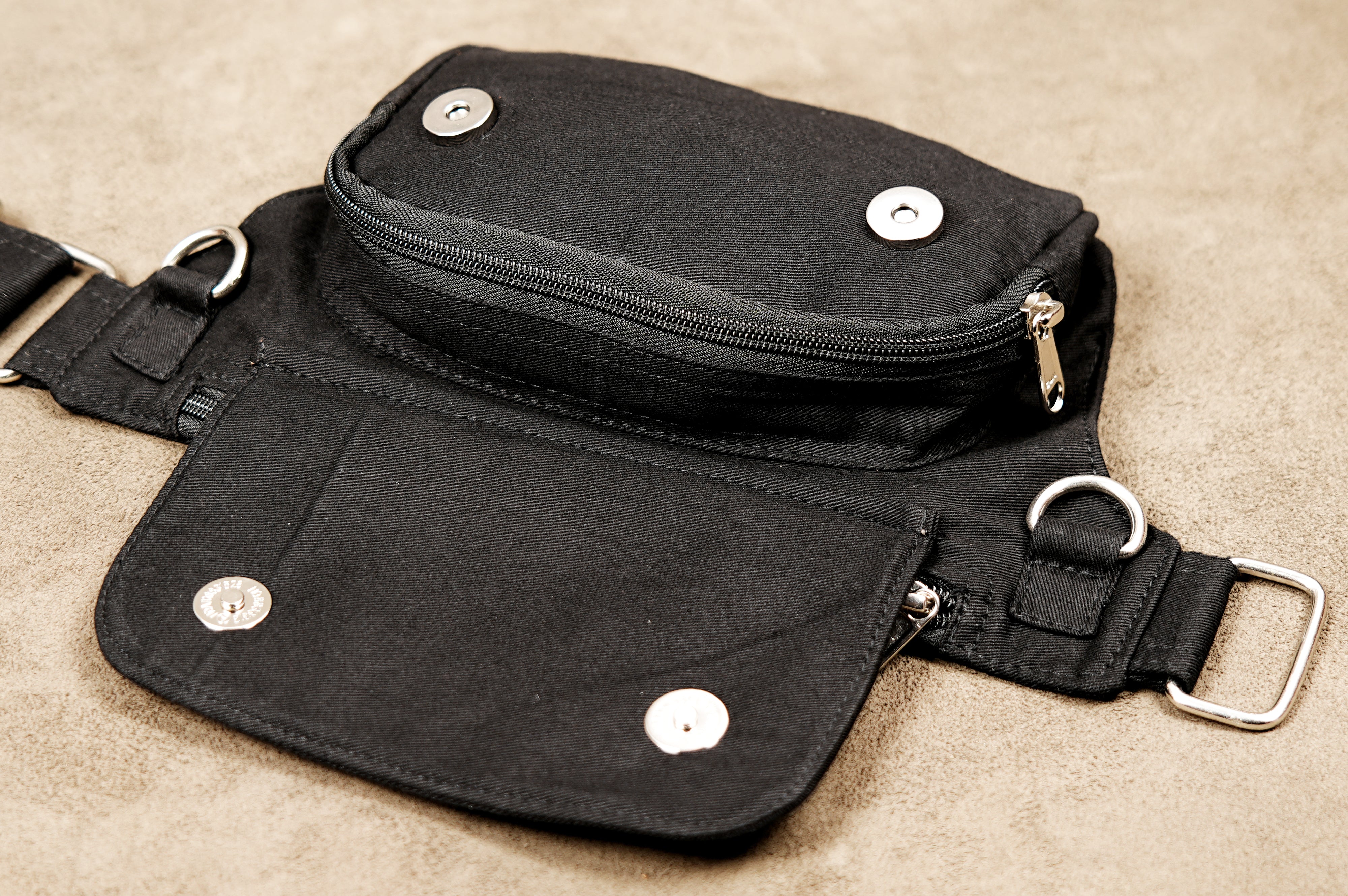 Unisex adjustable hip pouch made of heavy-duty black cotton canvas.