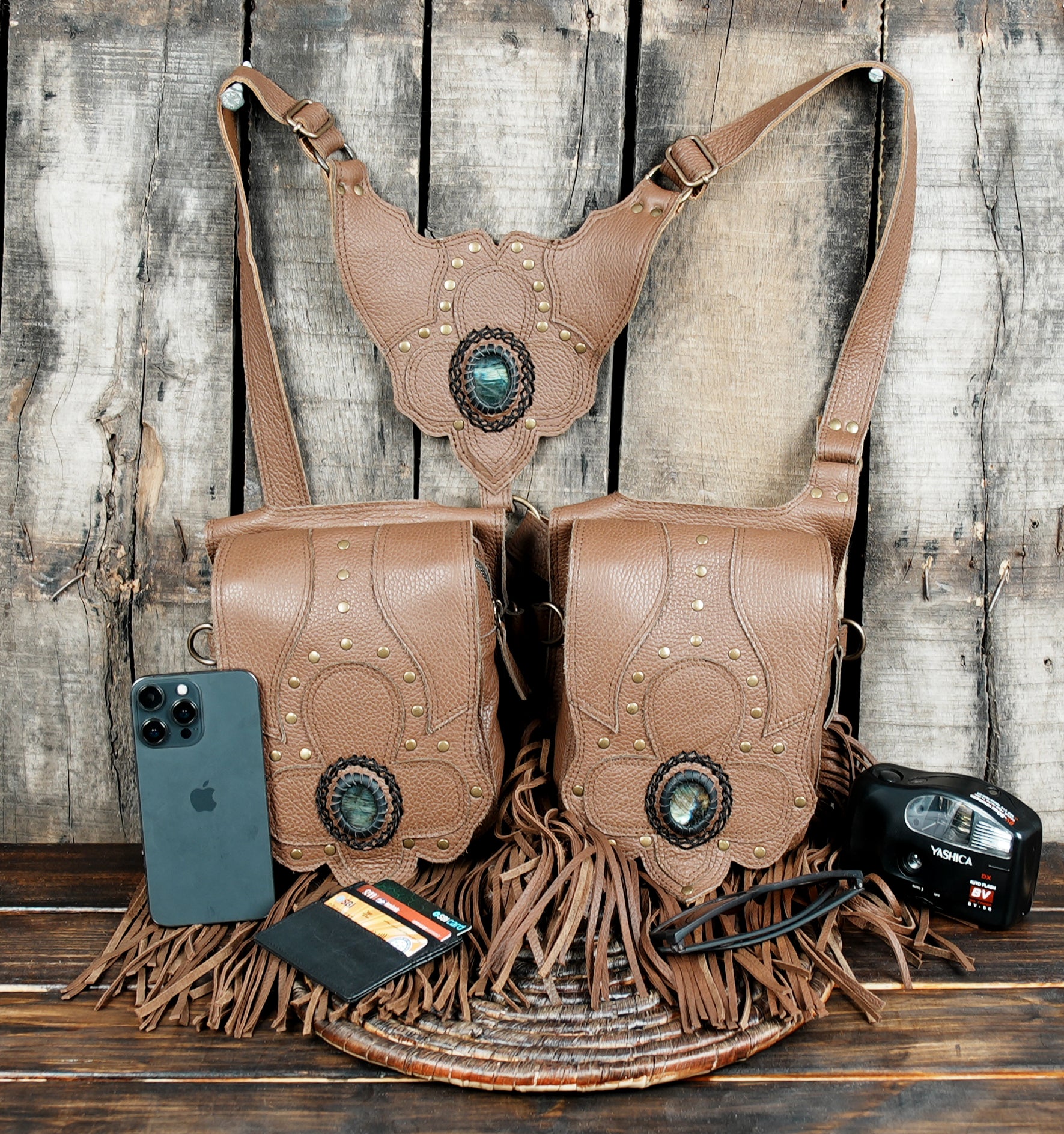 Tribal style leather shoulder holster with carved details and fringe