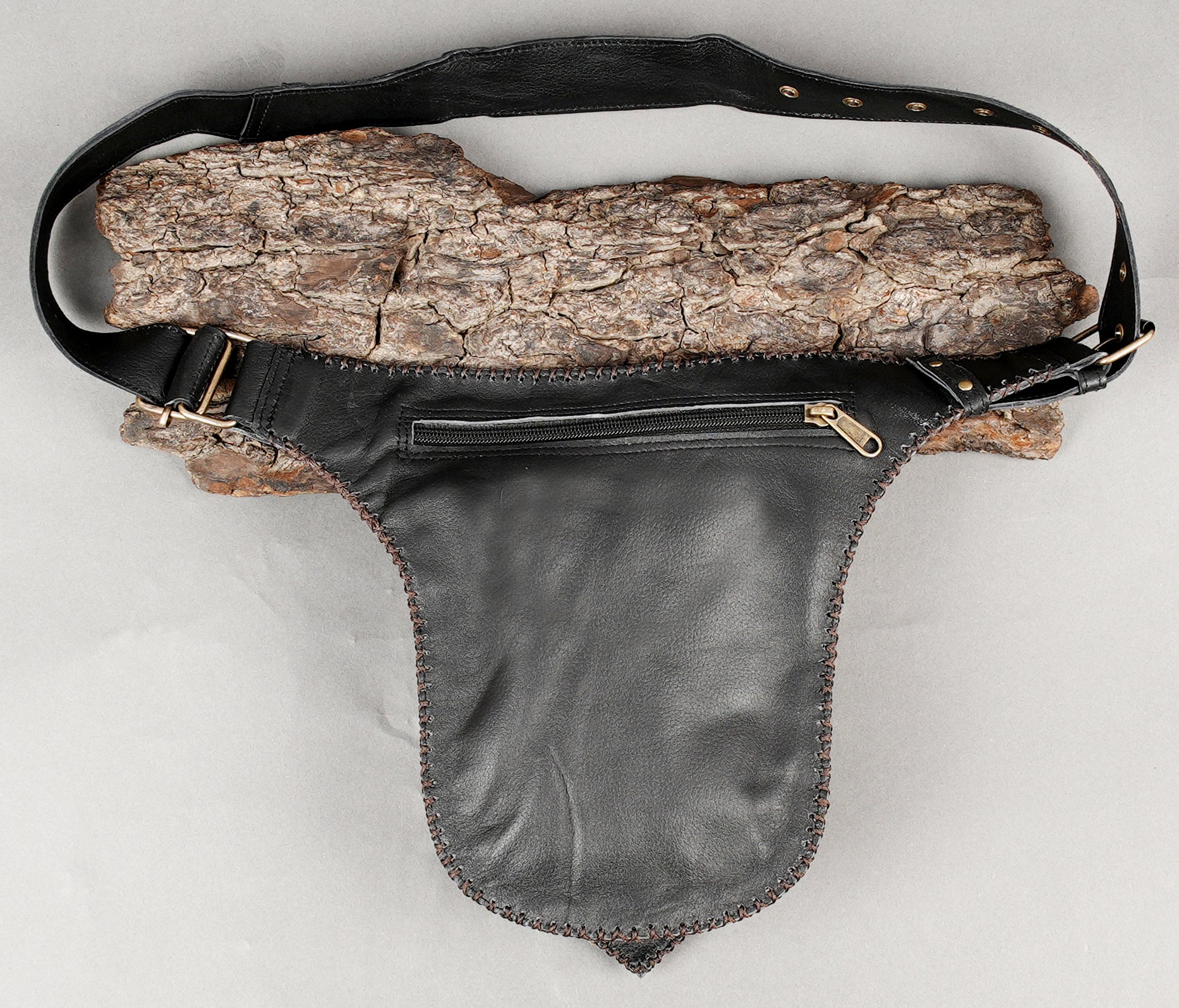 Black leather utility belt with gemstone centerpiece and rivets