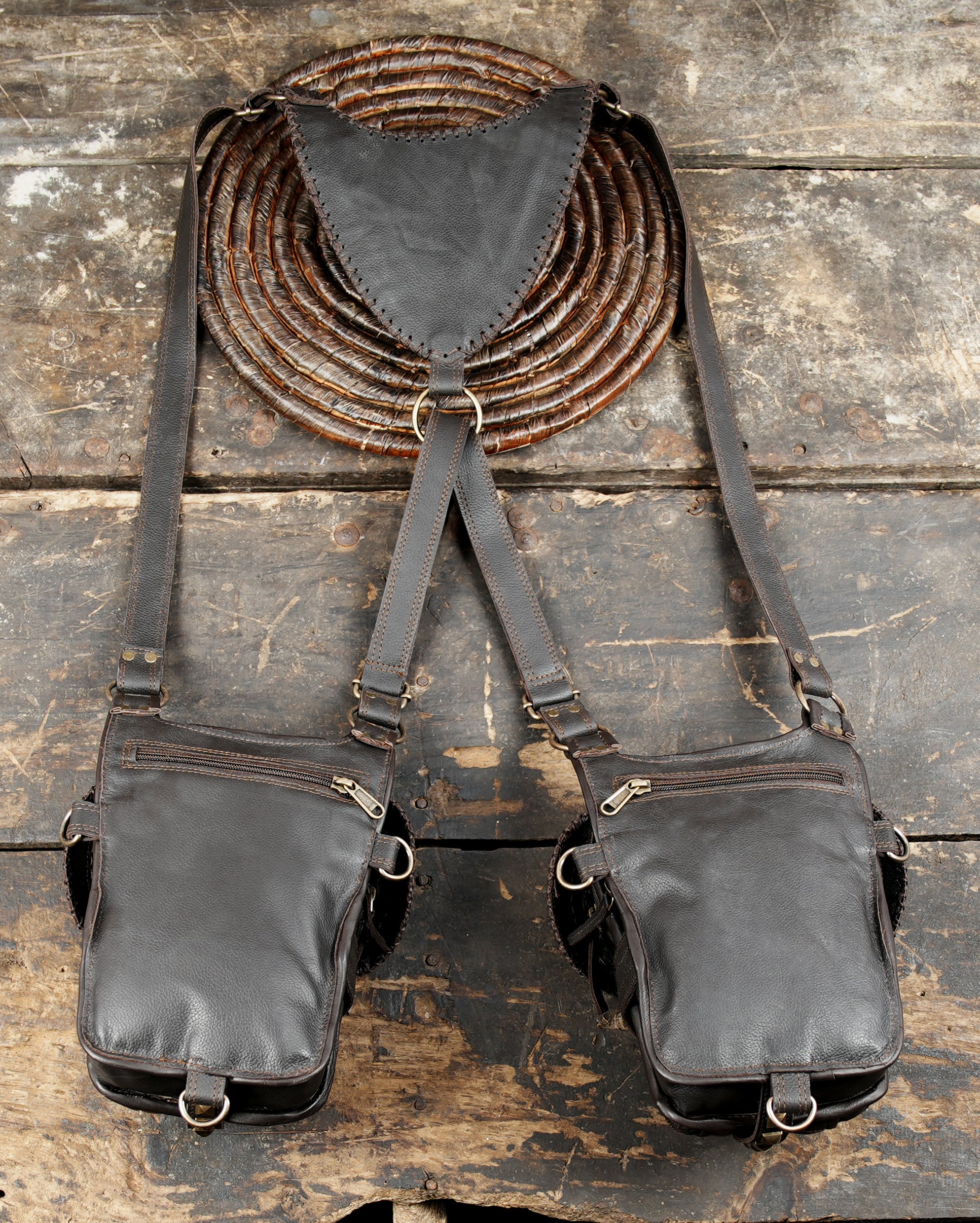 “Handmade tribal-style leather holster with dual storage and brass rivets”