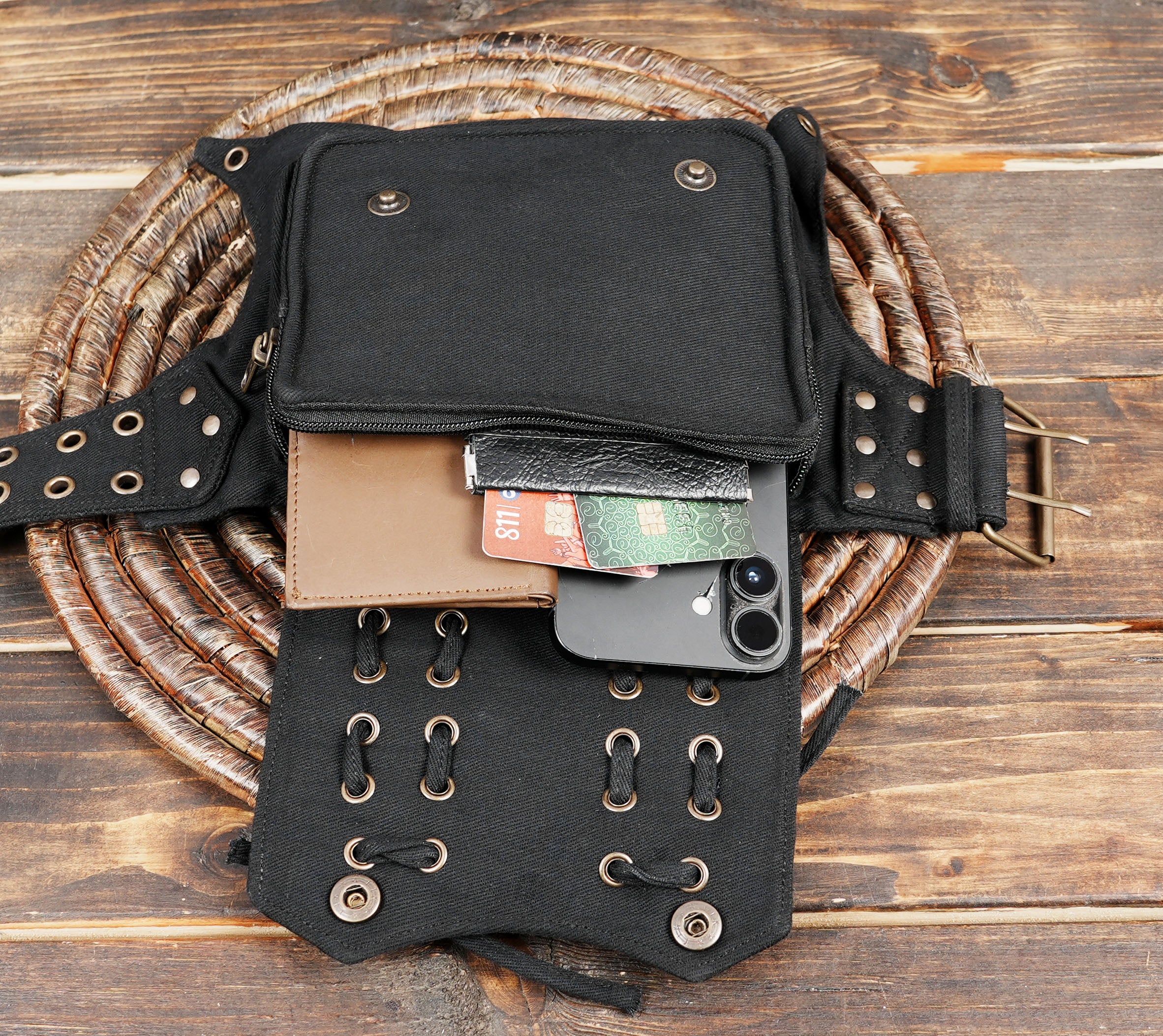 Handcrafted black cotton hip bag with decorative lacing and durable strap.