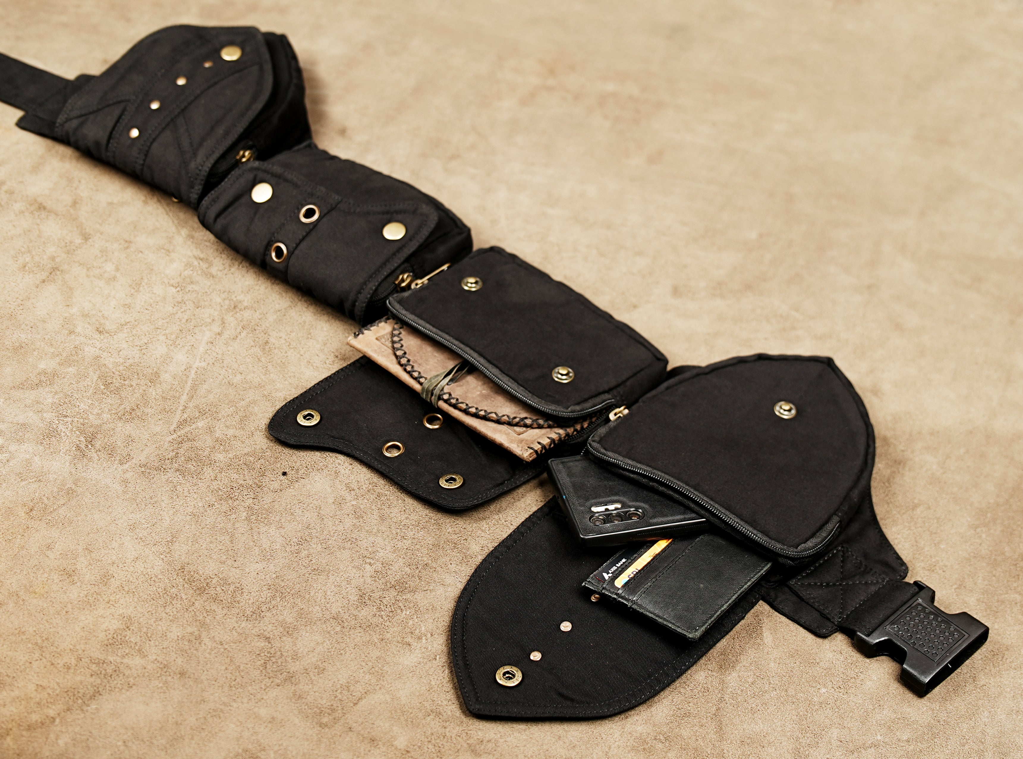 Black cotton utility belt with four pockets and brass snaps for urban streetwear