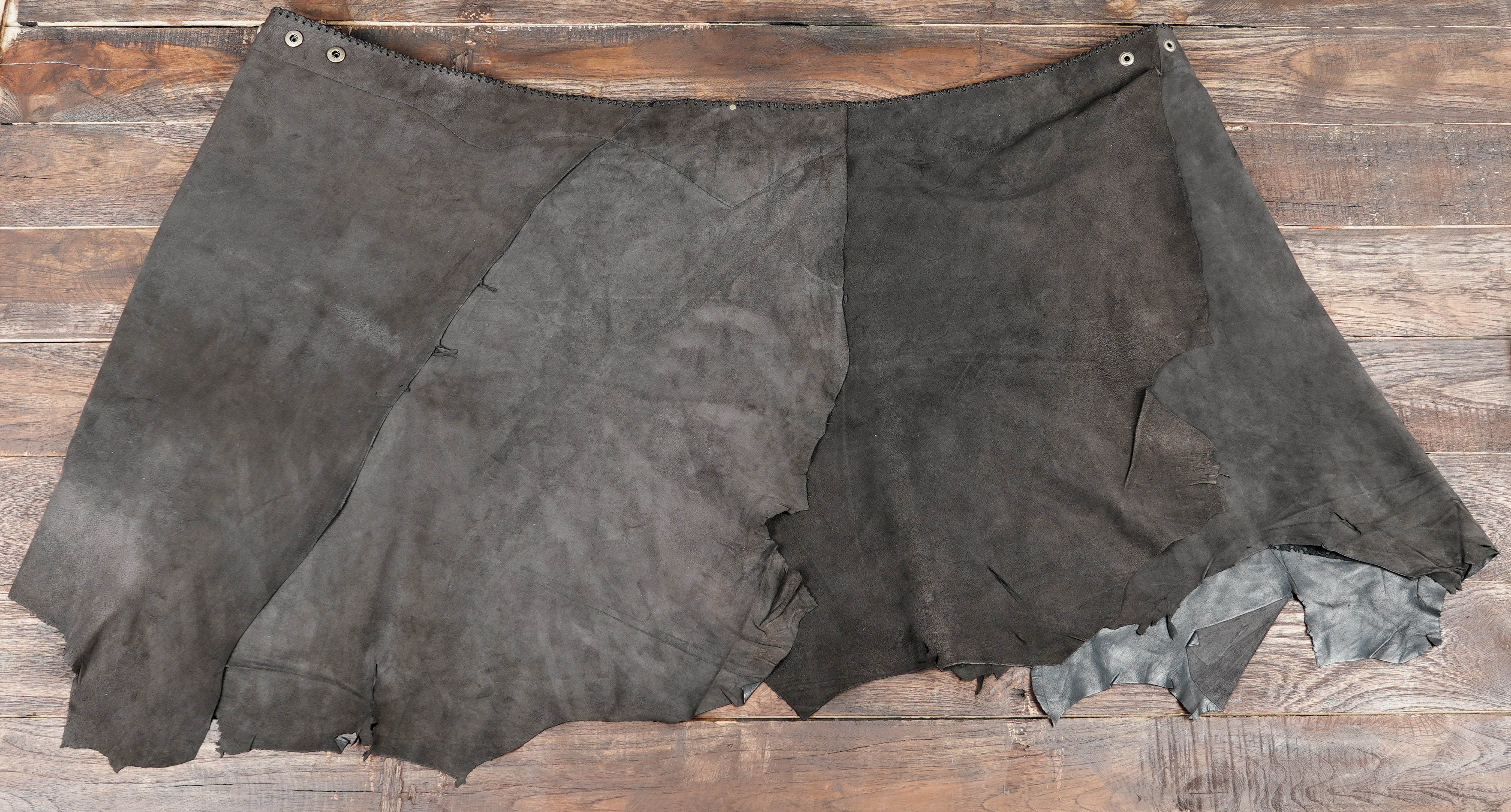 Women’s leather skirt with brass stud details.