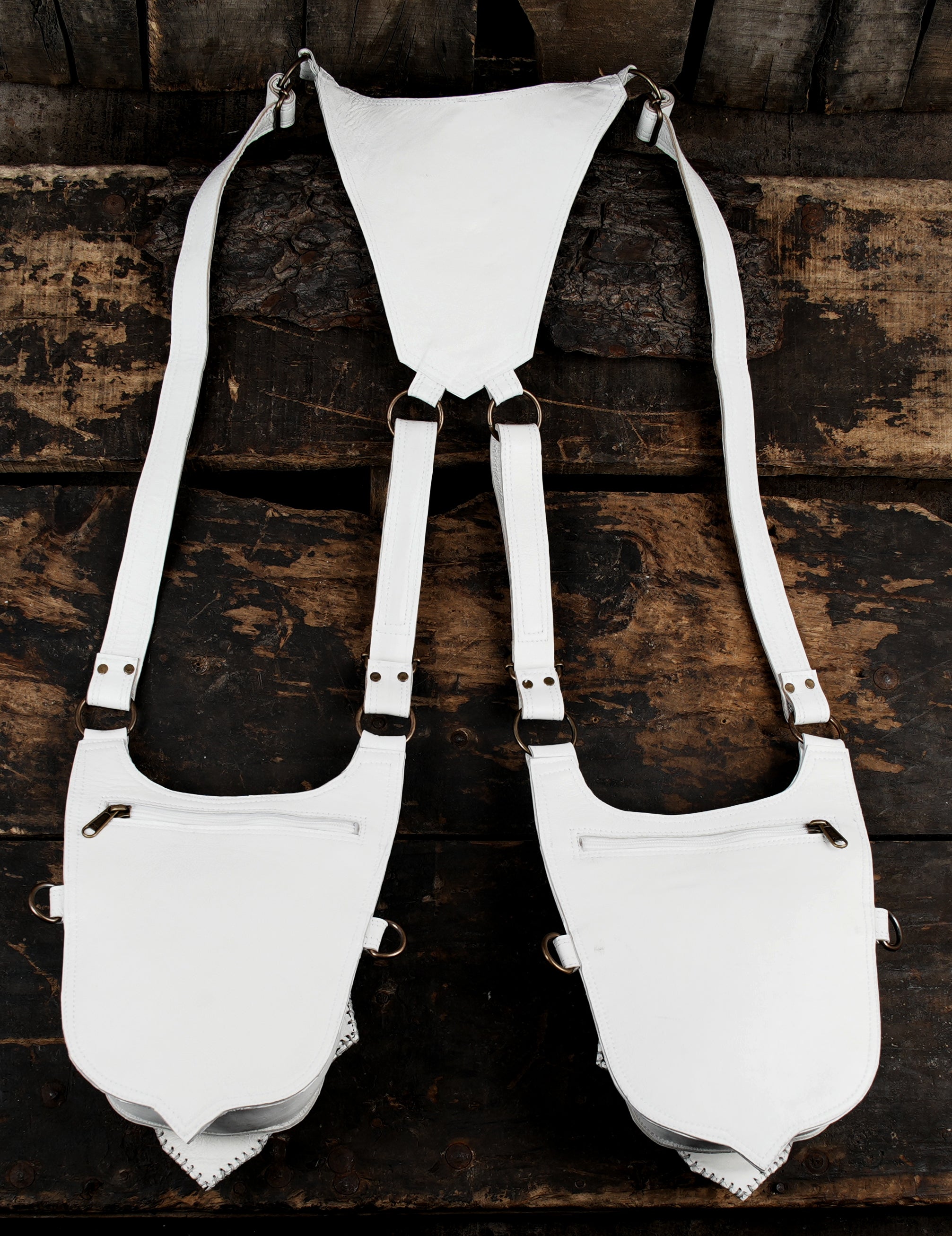 “White utility holster bag set with black stitched details and gemstone flaps”