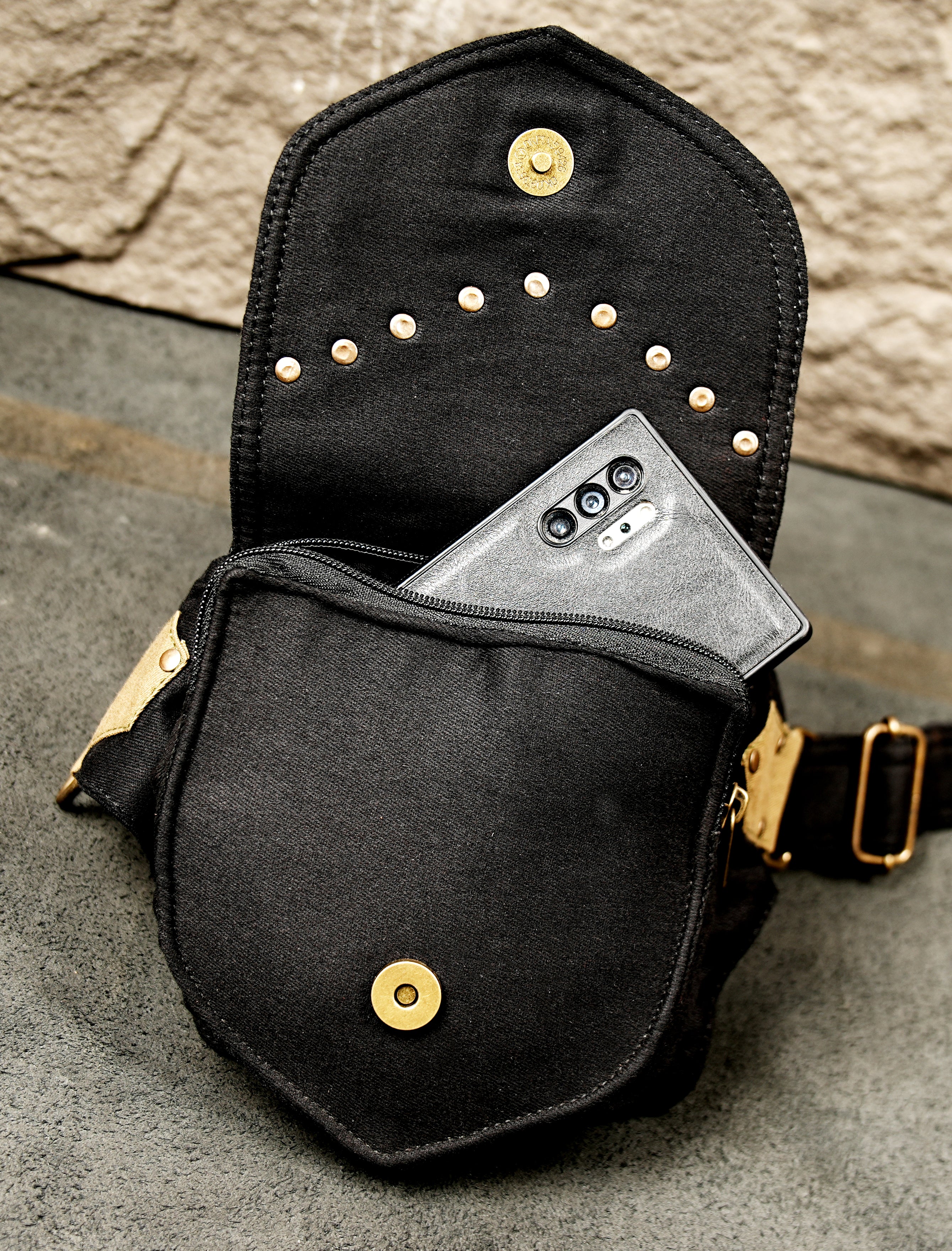 A compact yet functional utility belt bag with multiple attachment rings for accessorizing.