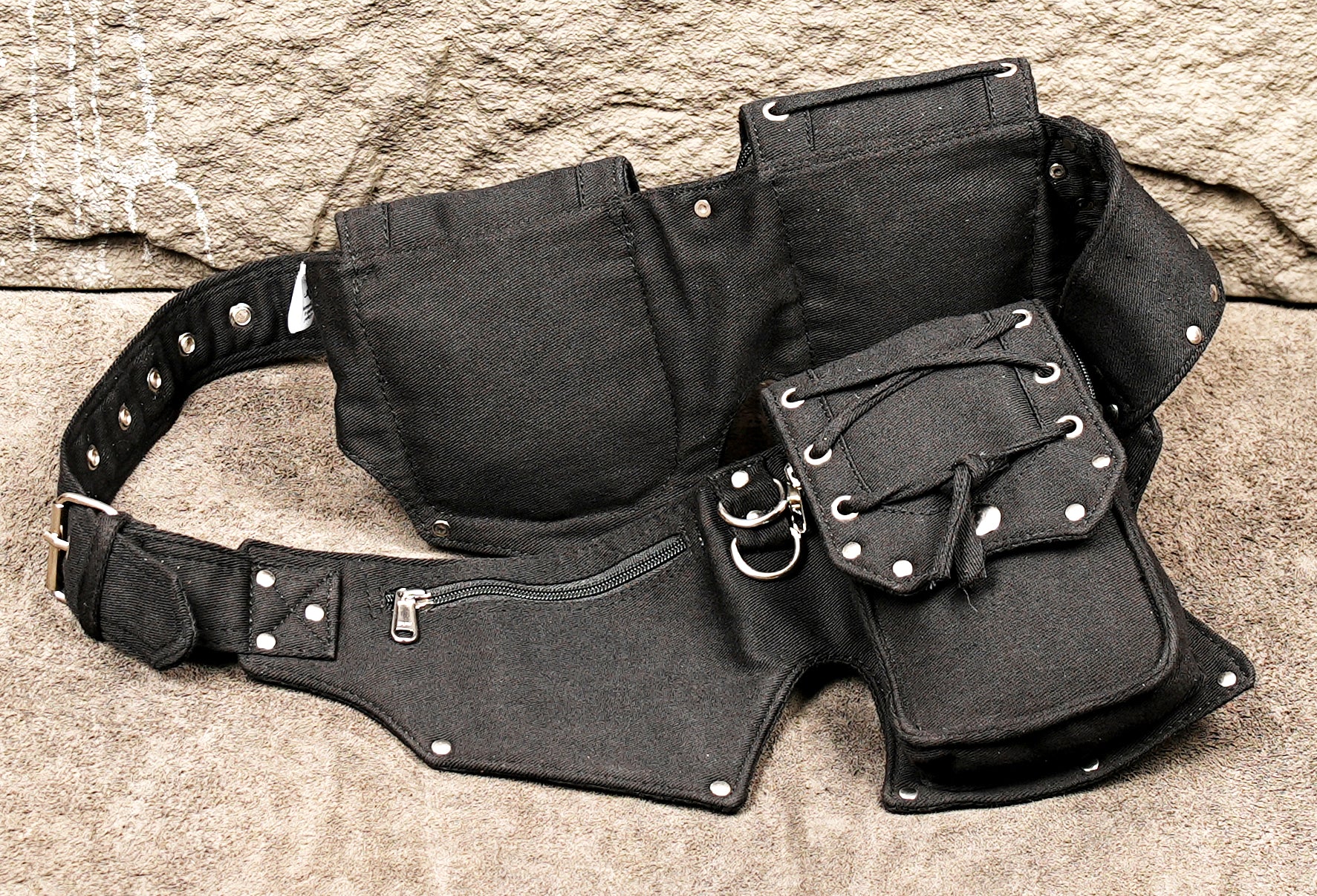 Low-profile black canvas utility belt for a modern, functional streetwear outfit.