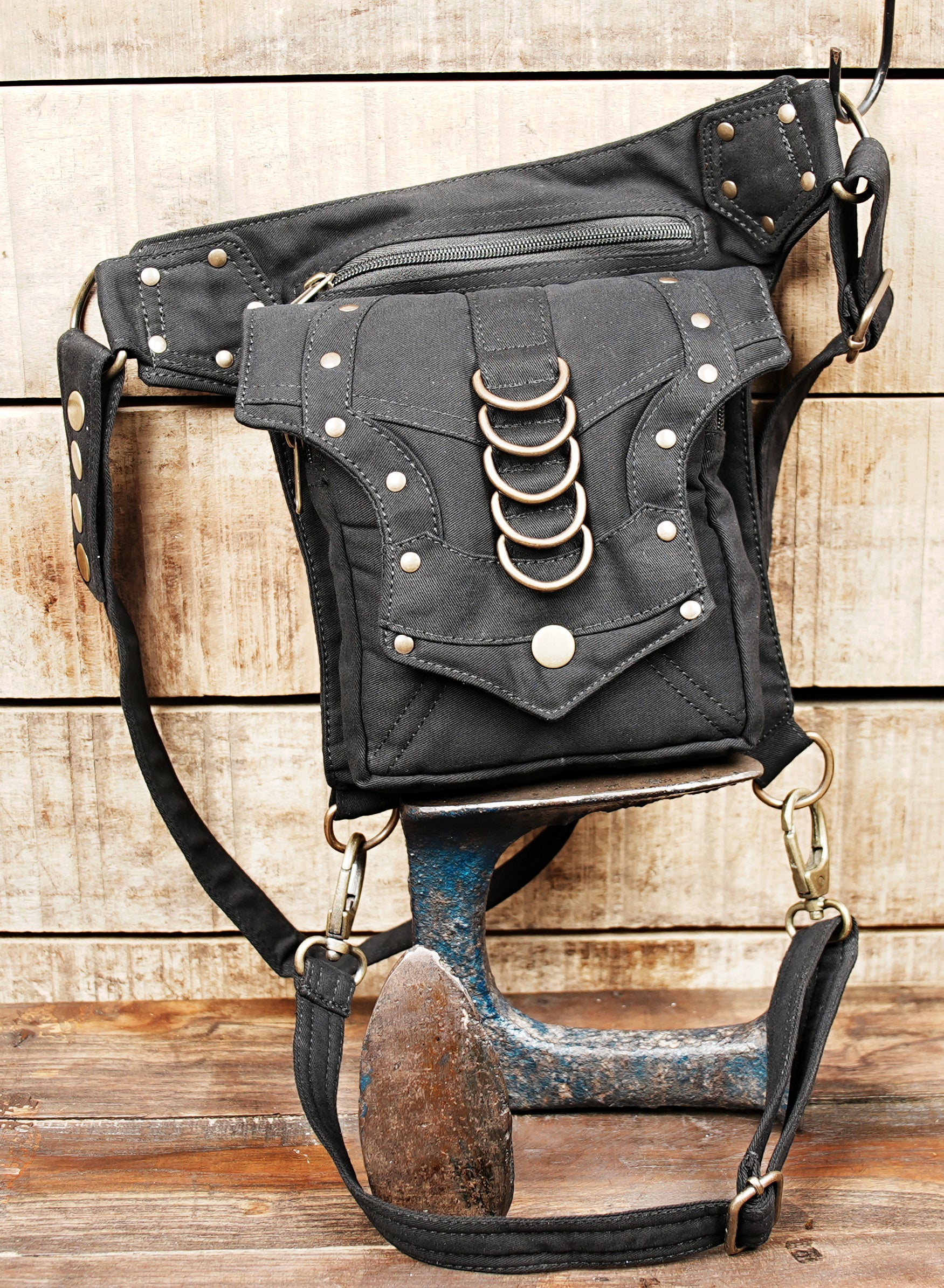 Tribal style canvas side thigh pack with front flap pocket and brass ring trims.