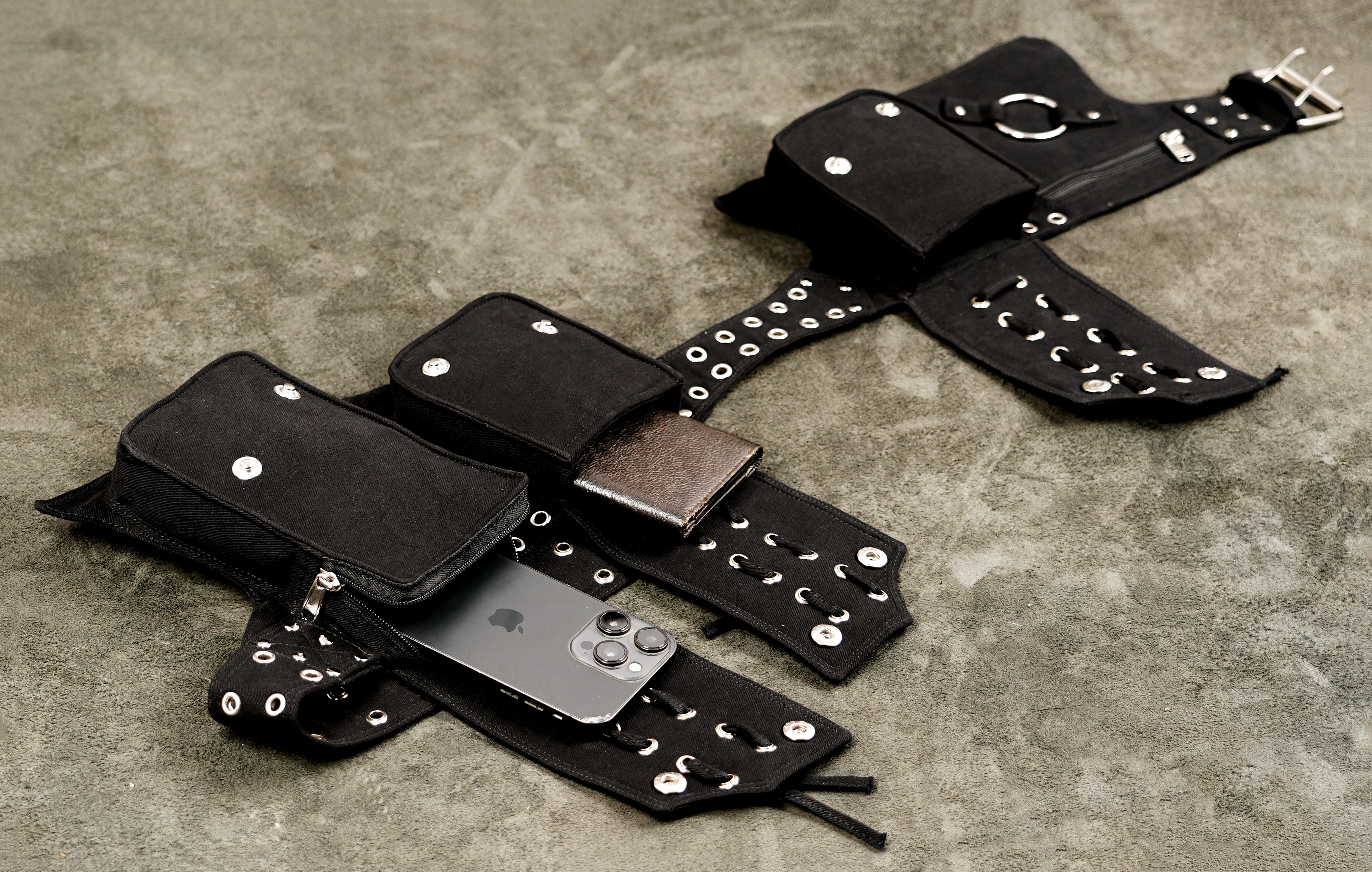Black canvas utility belt with metal O-ring and zippered pocket