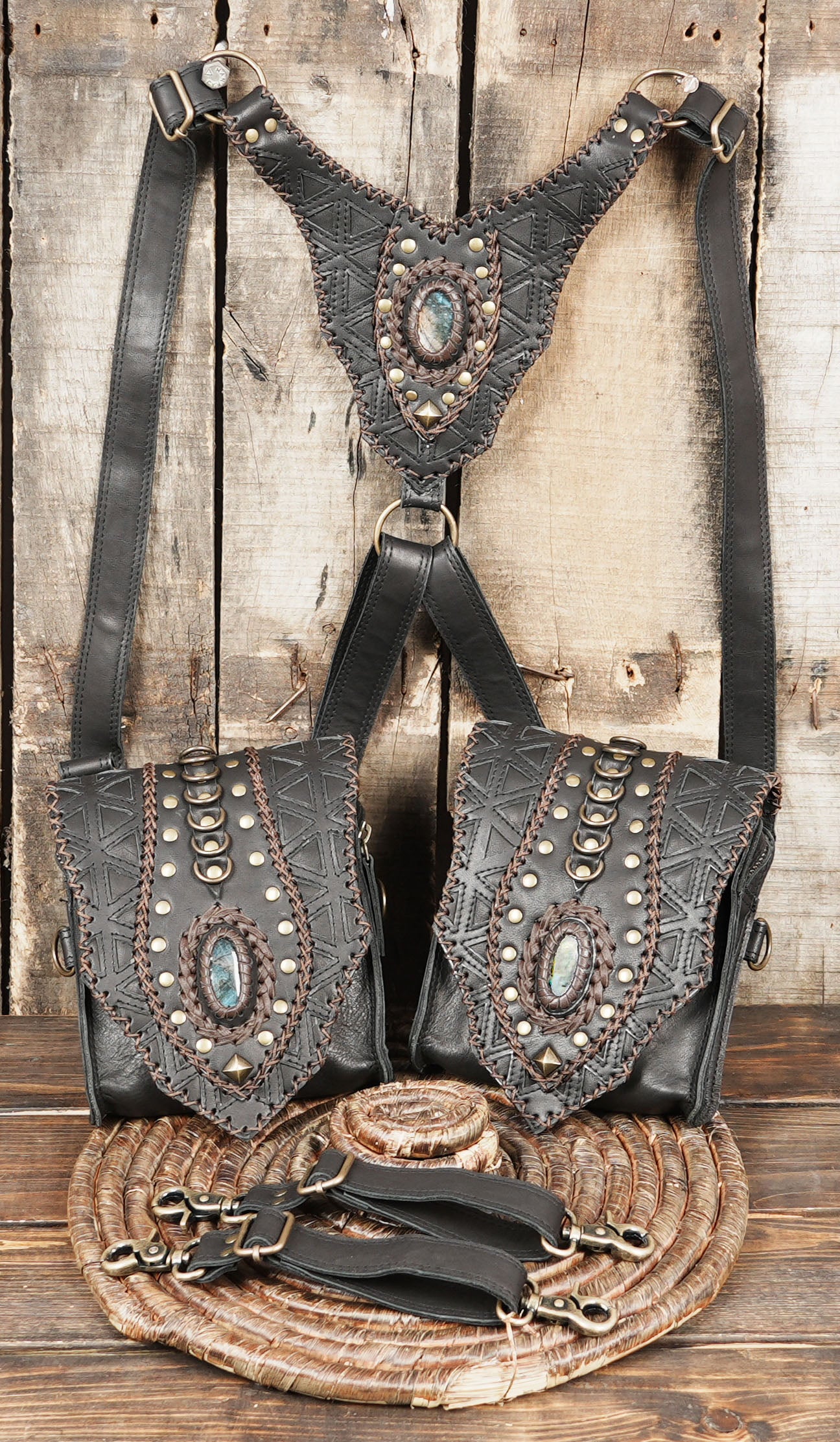 “Black leather shoulder holster with adjustable straps and gemstone panels”