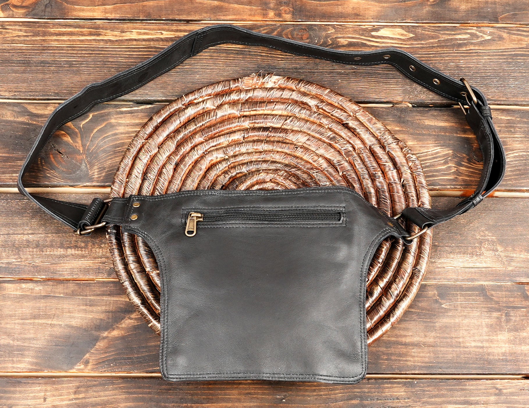 Premium leather hip bag with metal zipper and rivet accents