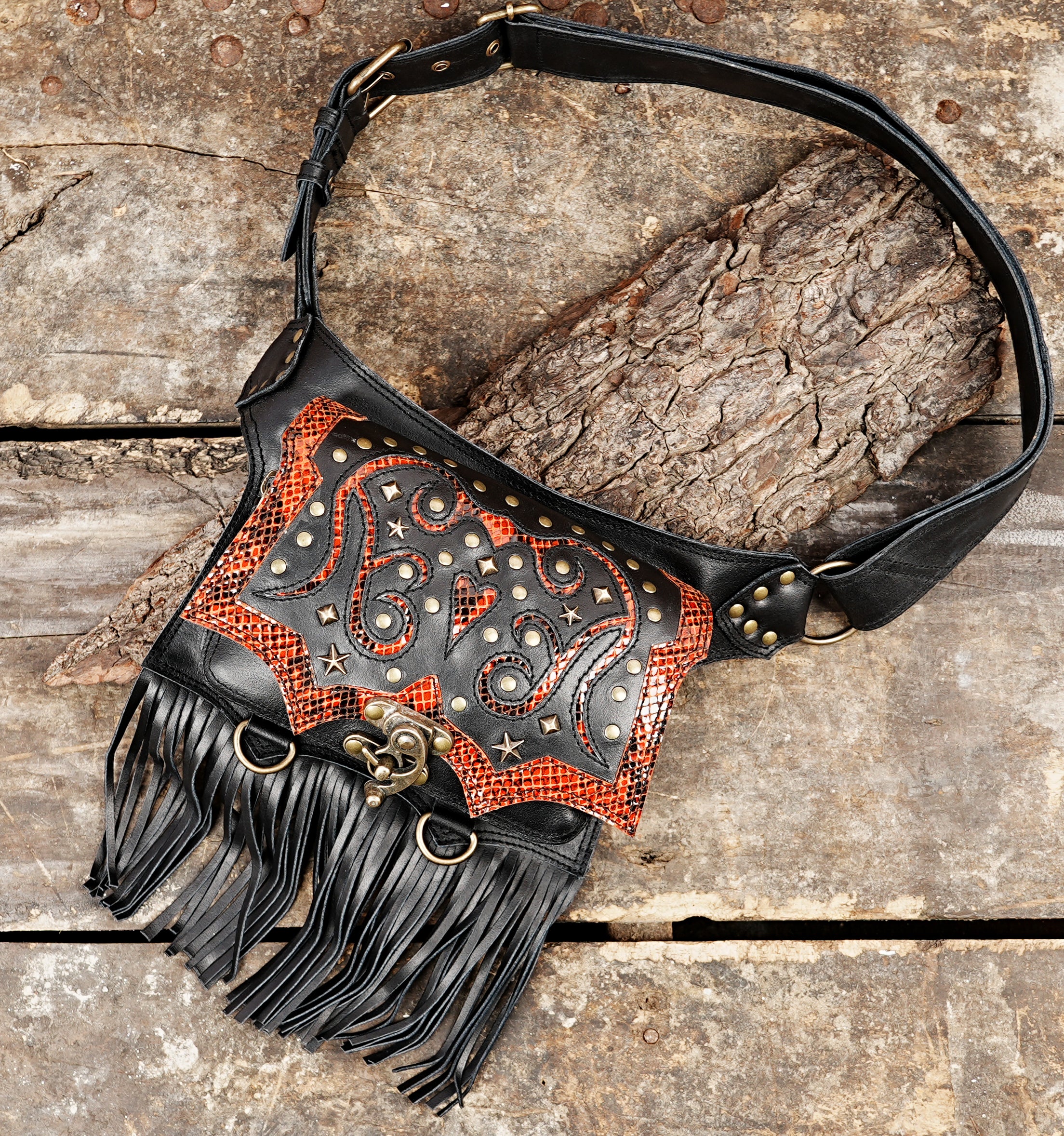 Statement leather waist belt with red snakeskin pattern and metal star studs