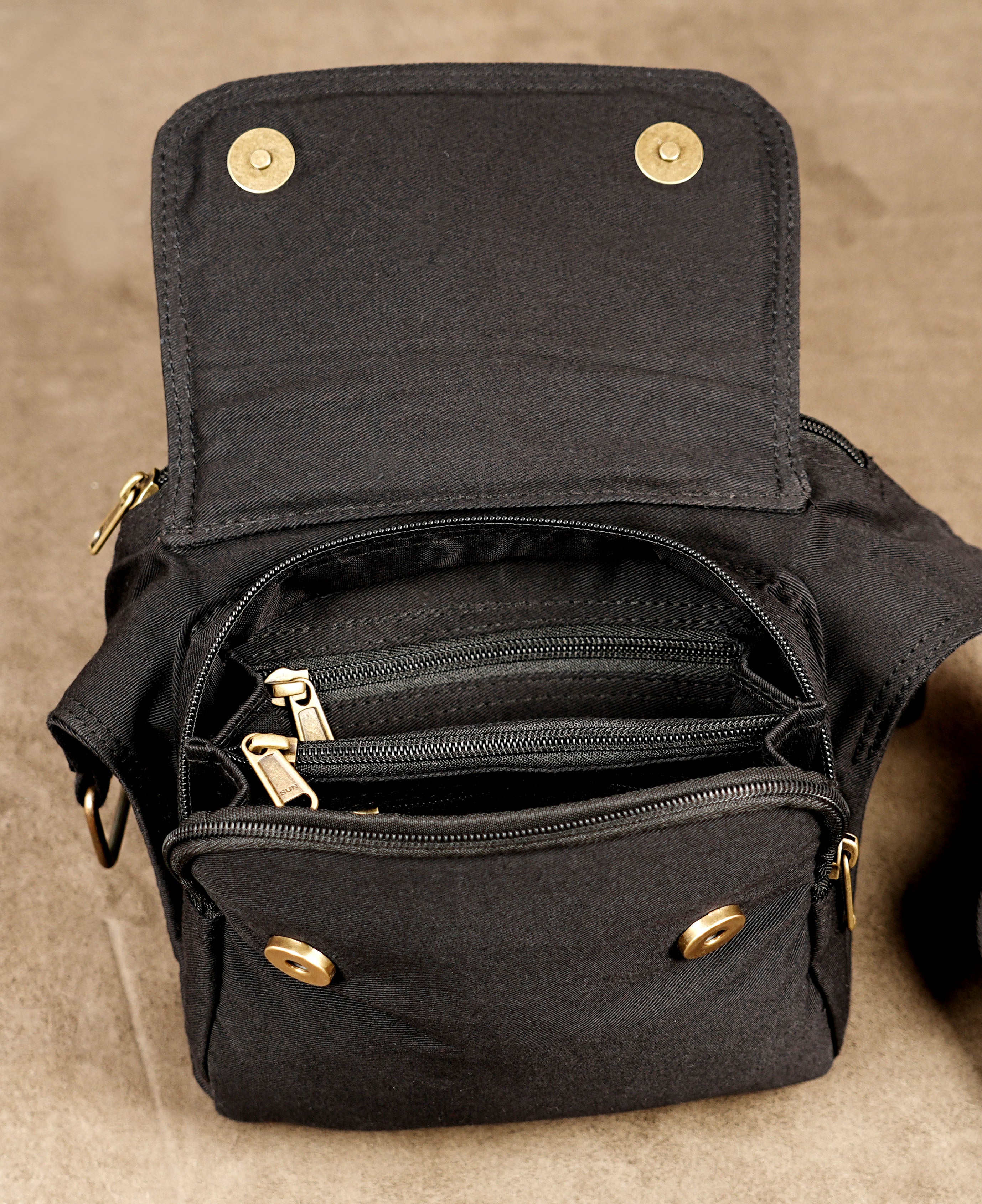 Black canvas hip pouch with adjustable waist belt and metal studs