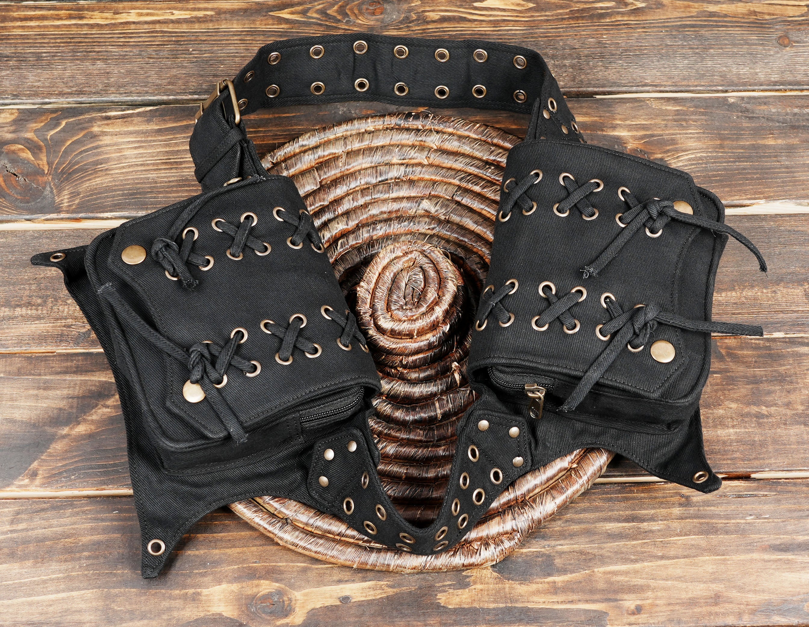 Versatile black cotton utility belt with decorative eyelets and pouches.