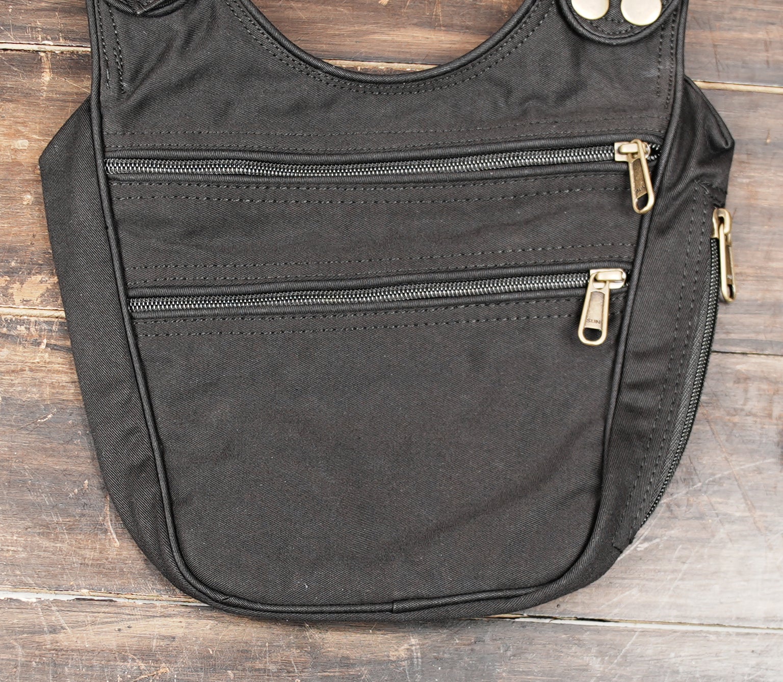 Black chest pouch with adjustable straps and storage pockets