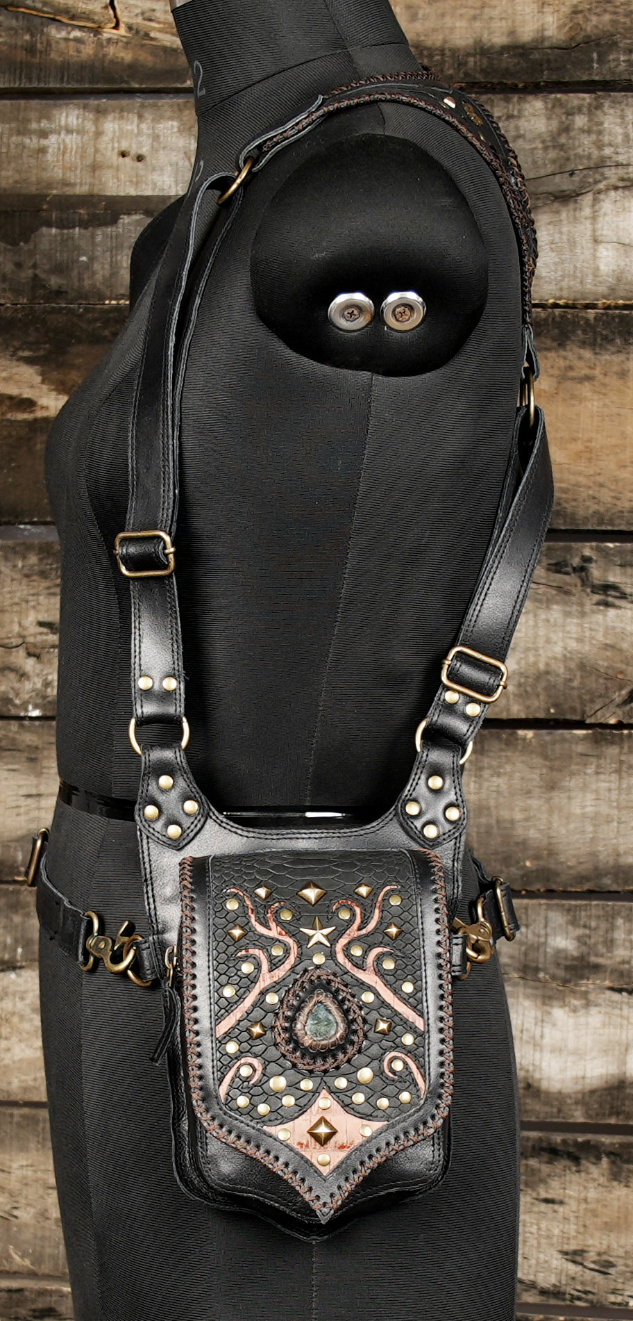 inspired leather holster with copper etching and gemstone design”