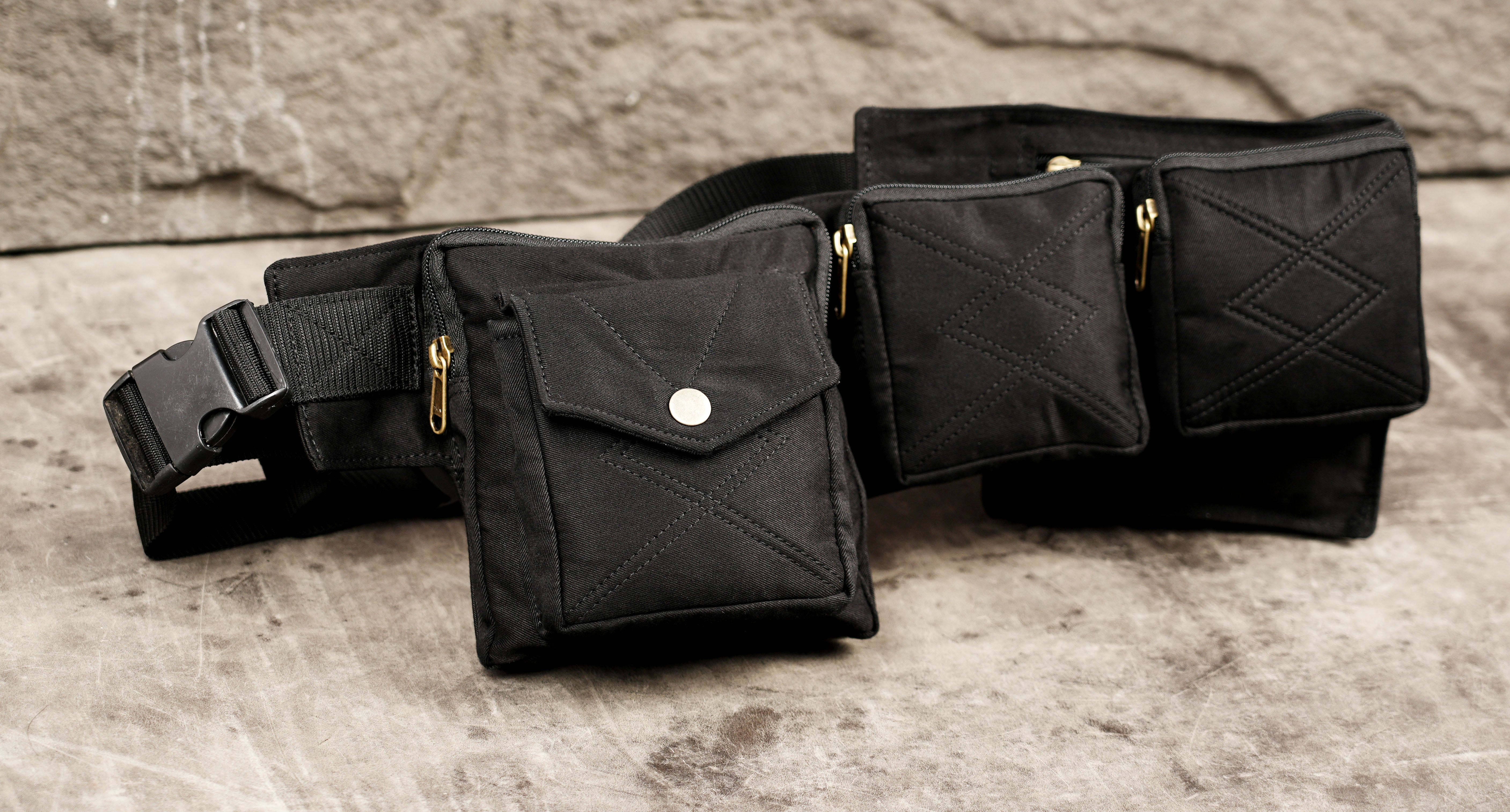 Black cotton pocket belt with gold zippers and snap closures