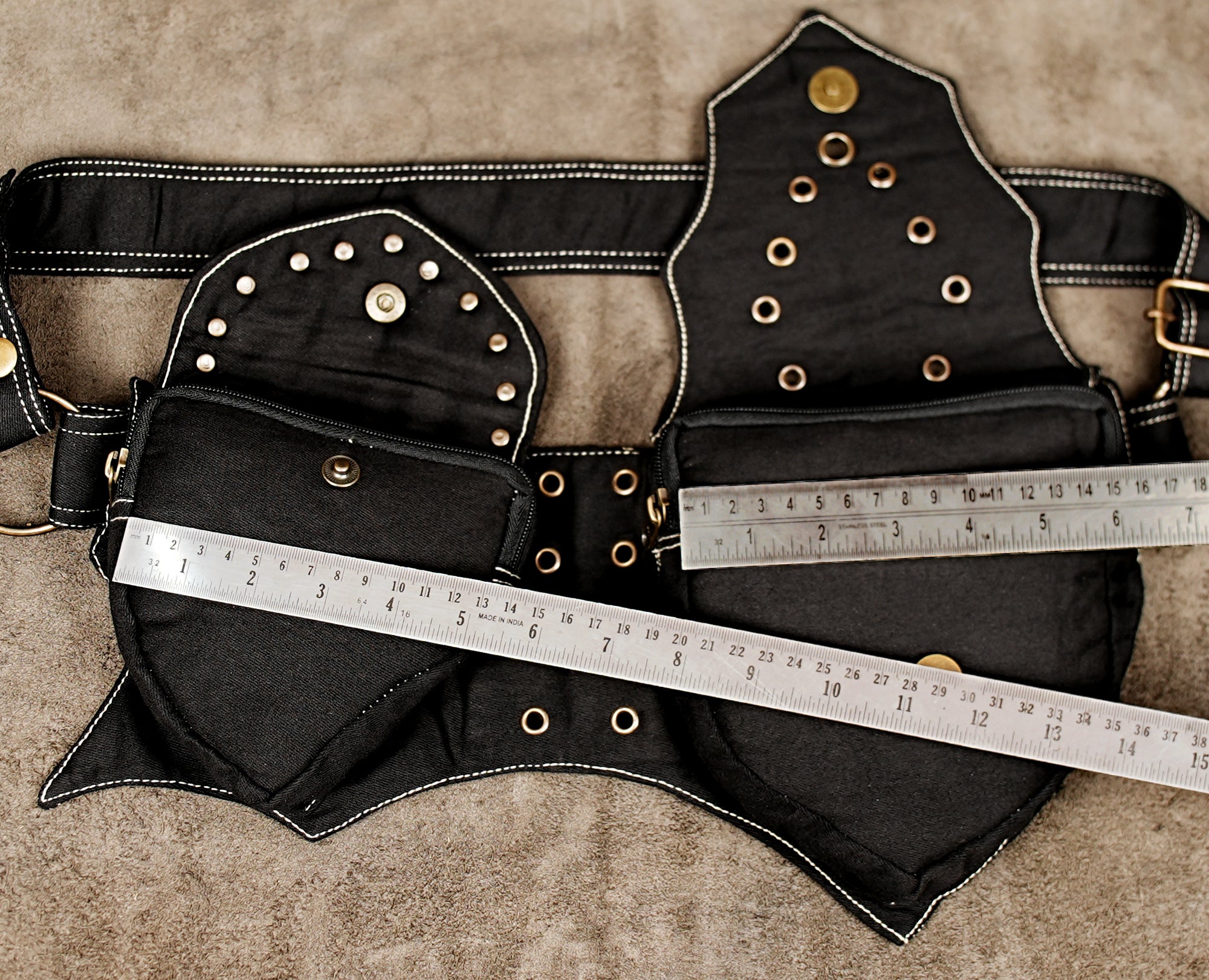 Black cotton bum bag with studded pocket and eyelet center panel