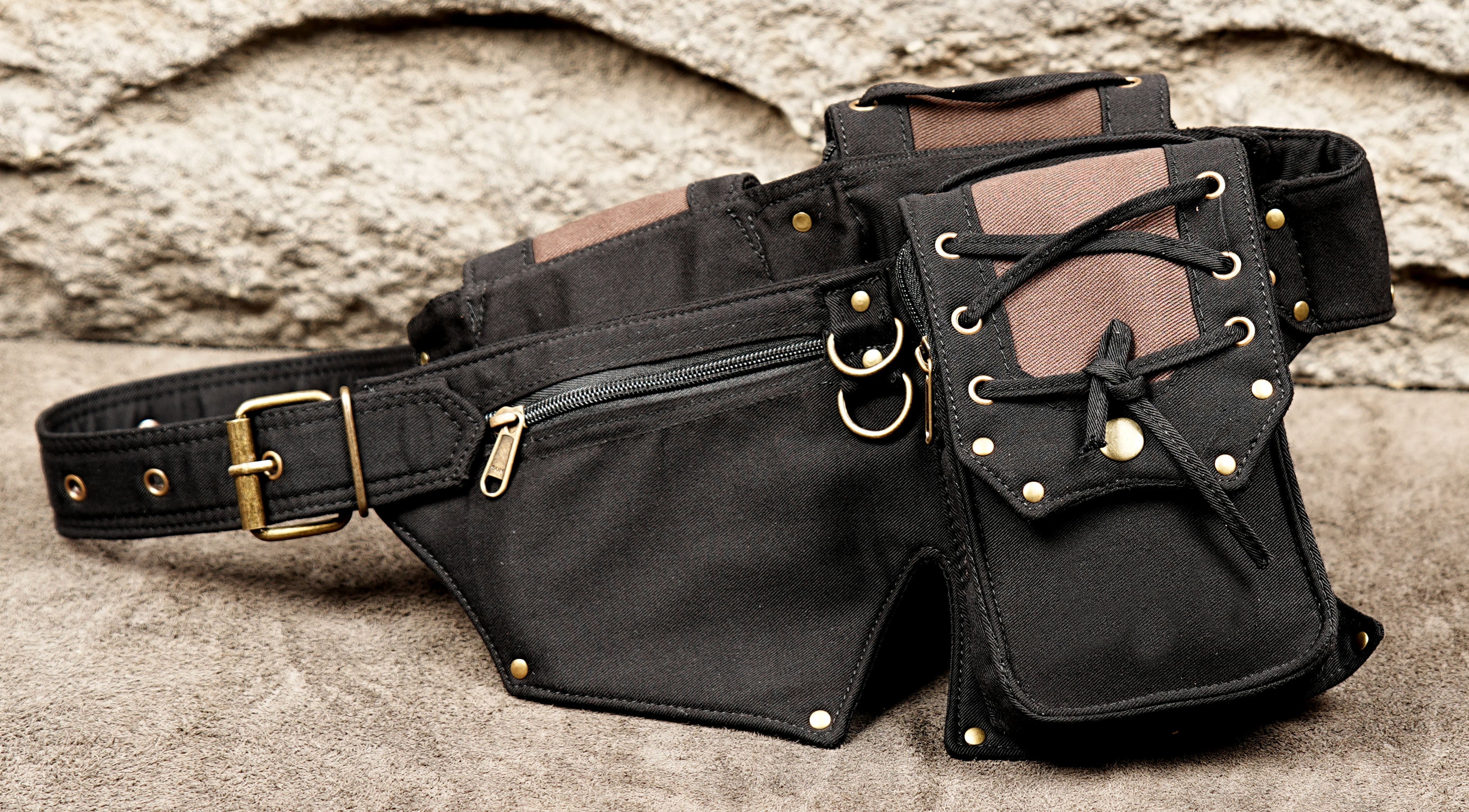 Black canvas utility belt with lace-up detailing and metal eyelets