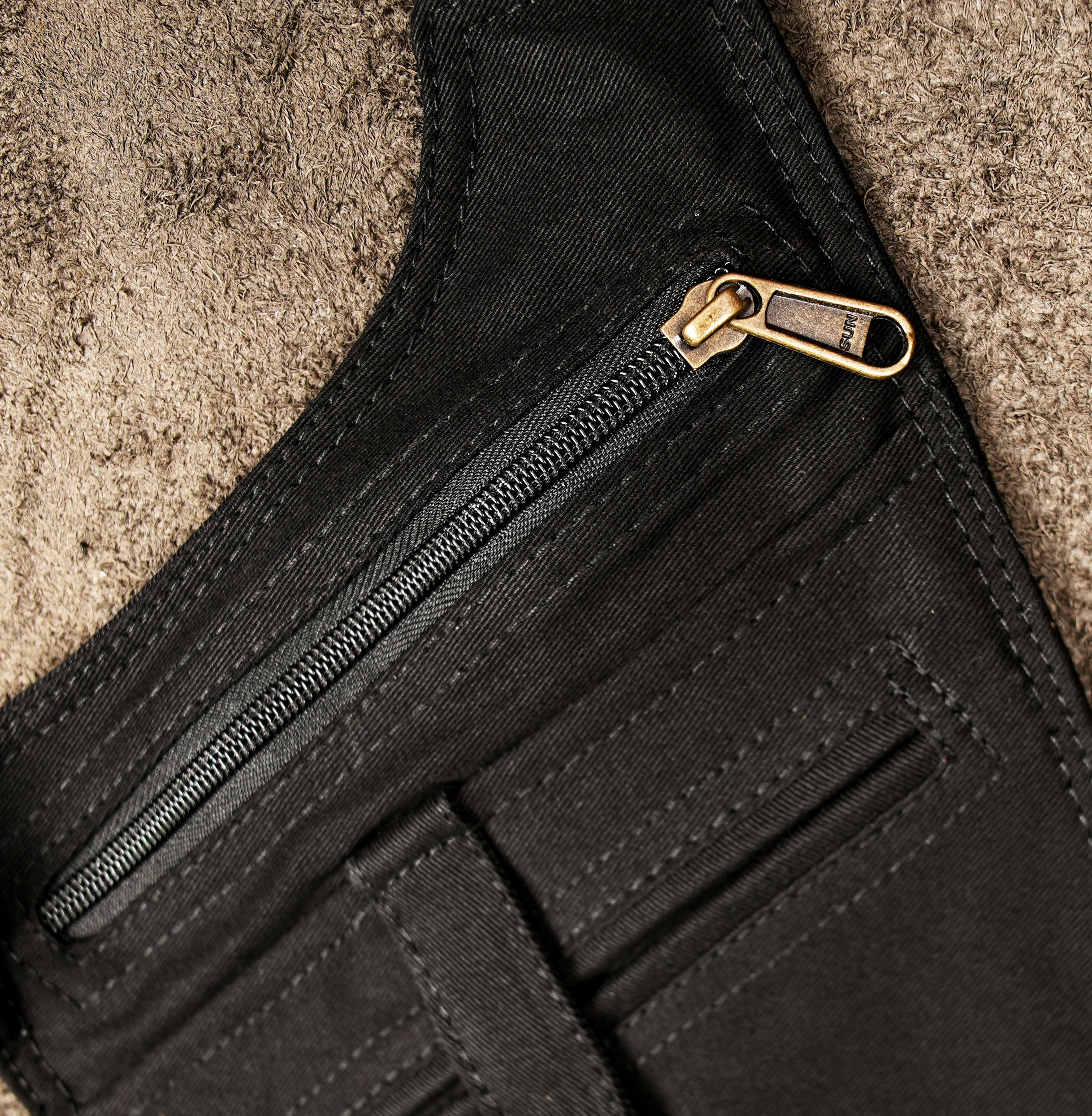 Black cotton holster vest bag with brass hardware and zipper pockets