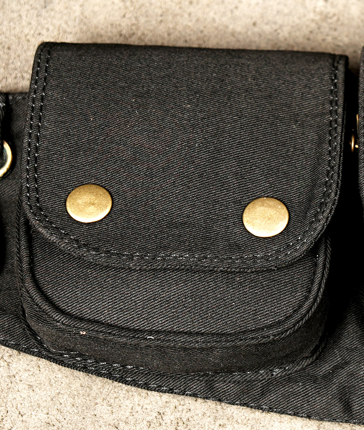 Adjustable black cotton waist belt with eyelet strap and buckle