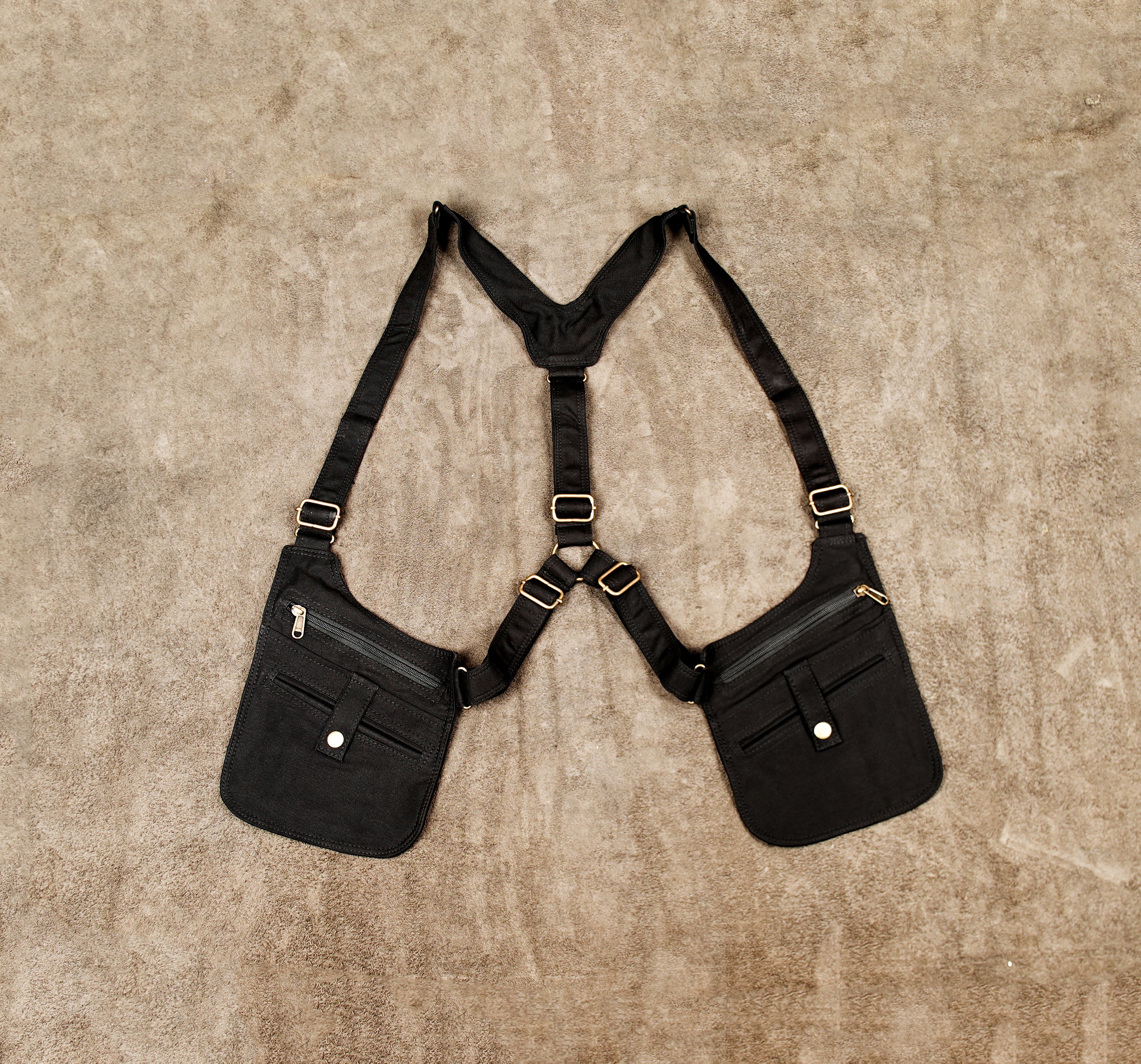 Black cotton shoulder holster bag with dual zip pockets and adjustable straps