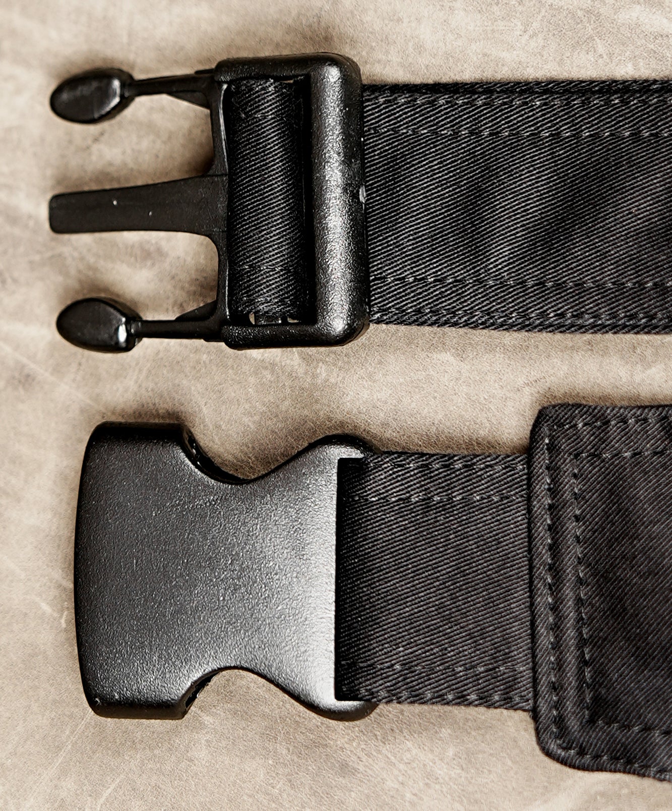 Black hip pouch with snap button pocket and velcro top compartment.