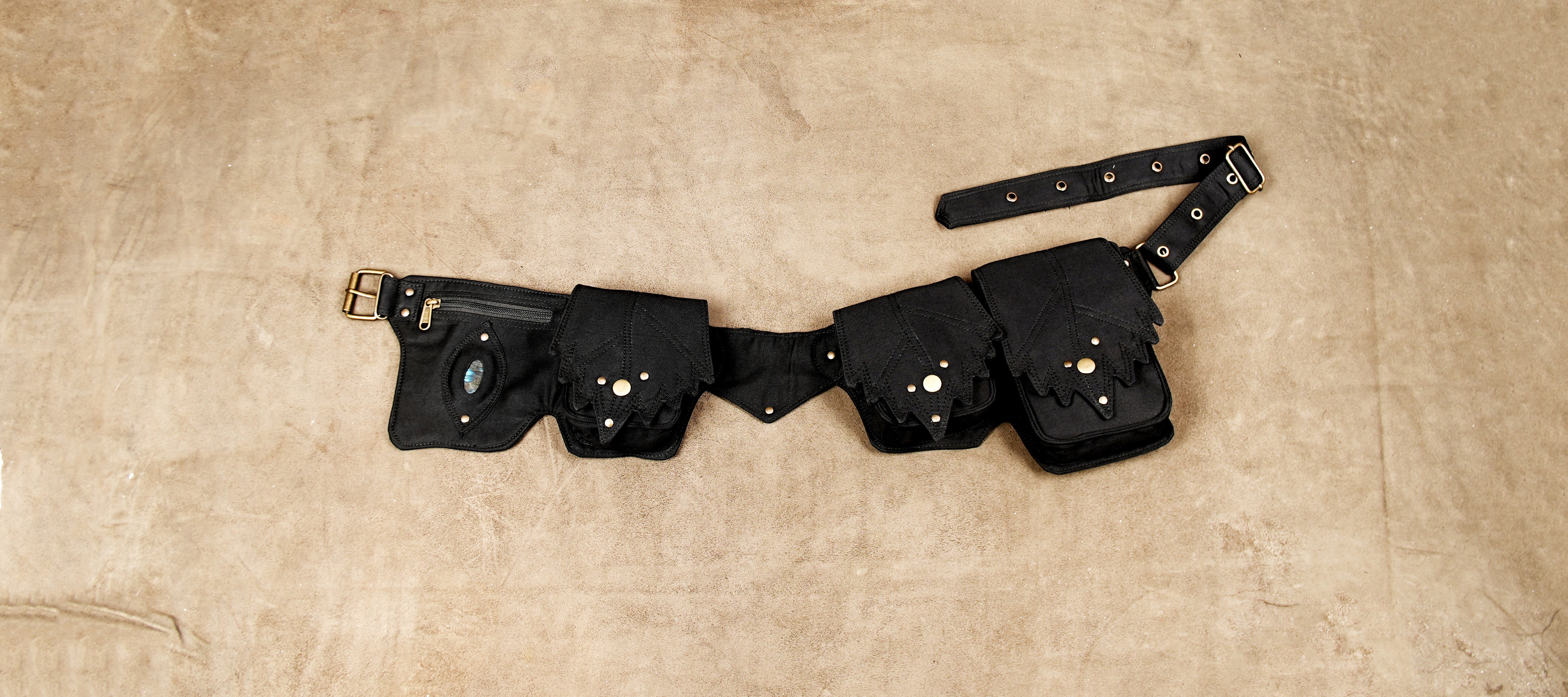 Black cotton utility waist belt with four pockets, leaf-shaped flaps and brass snap buttons