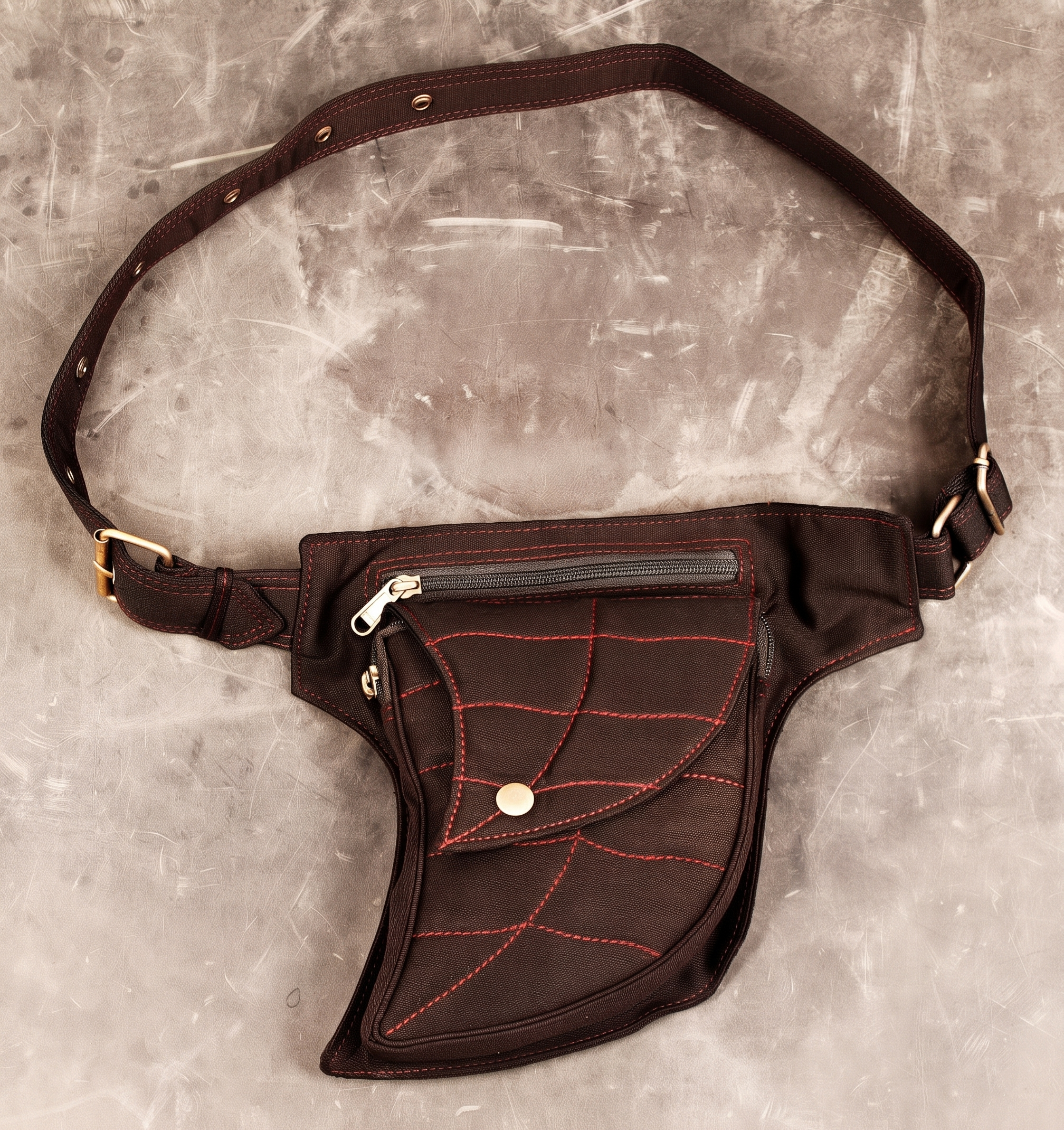 Gothic spider web hip bag in black cotton with red contrast stitching and adjustable brass buckle strap