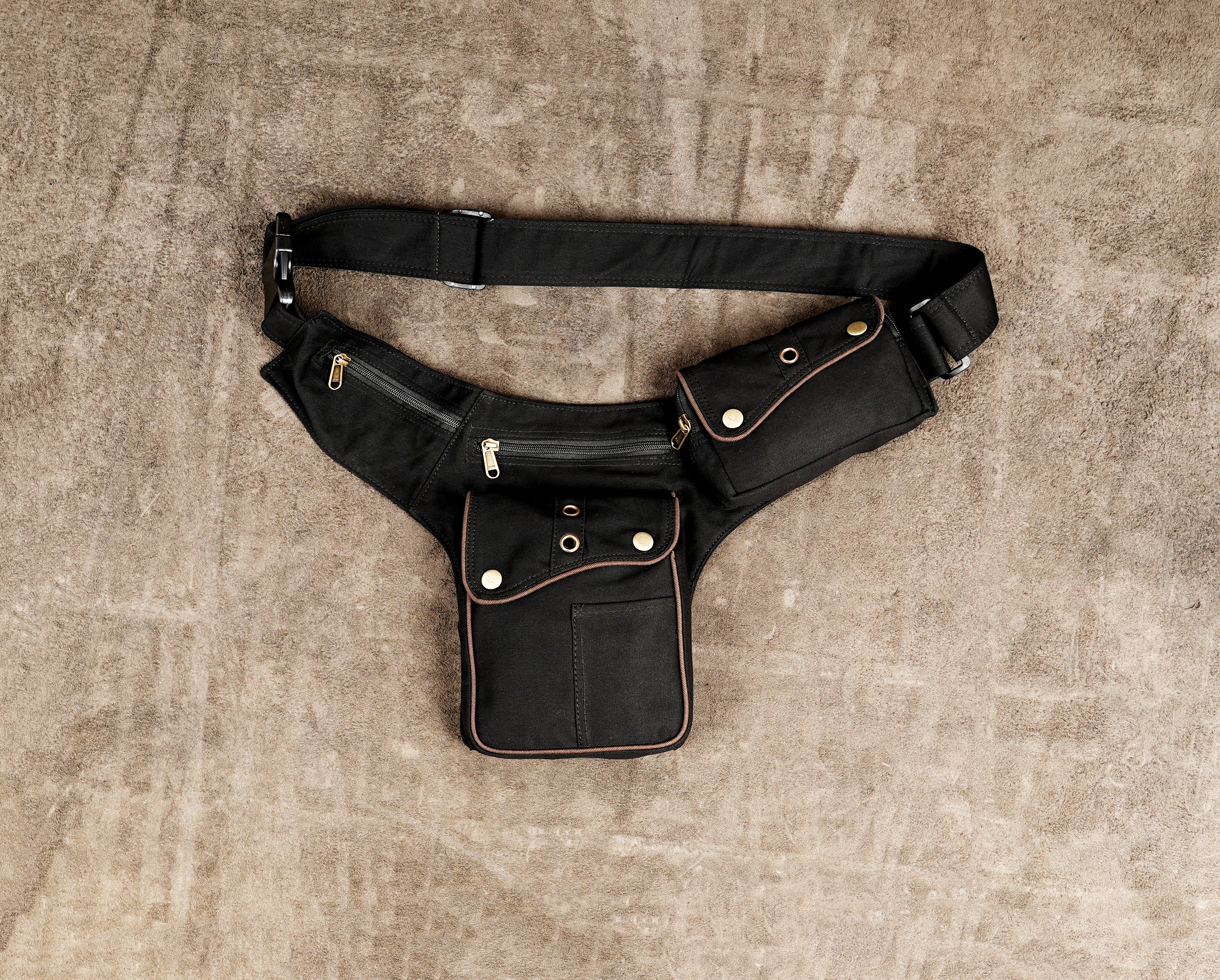 Black cotton waist belt with multiple zip pockets and brass snap buttons