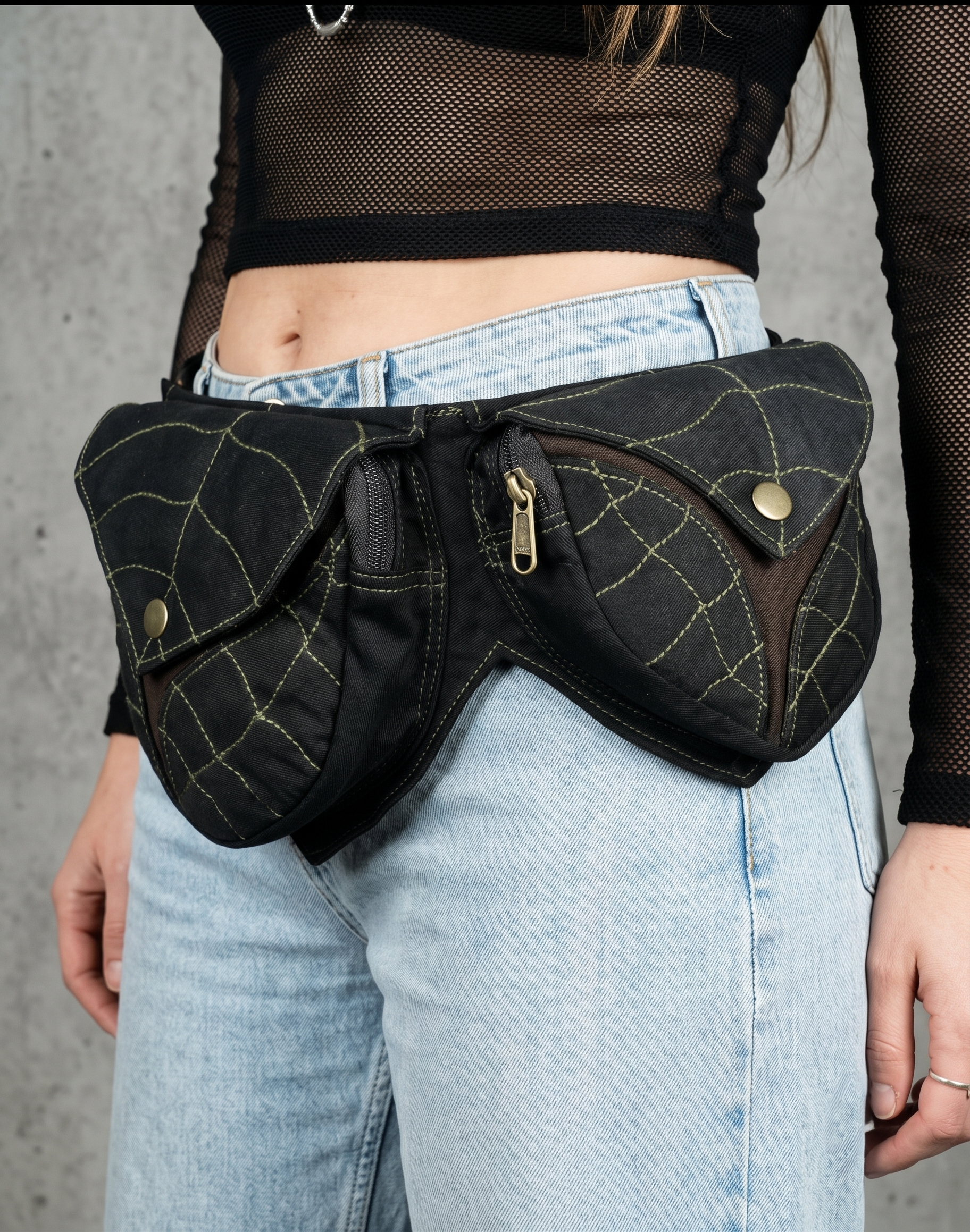 Black cotton utility waist belt with two pockets, green leaf vein stitching and brass snap buttons