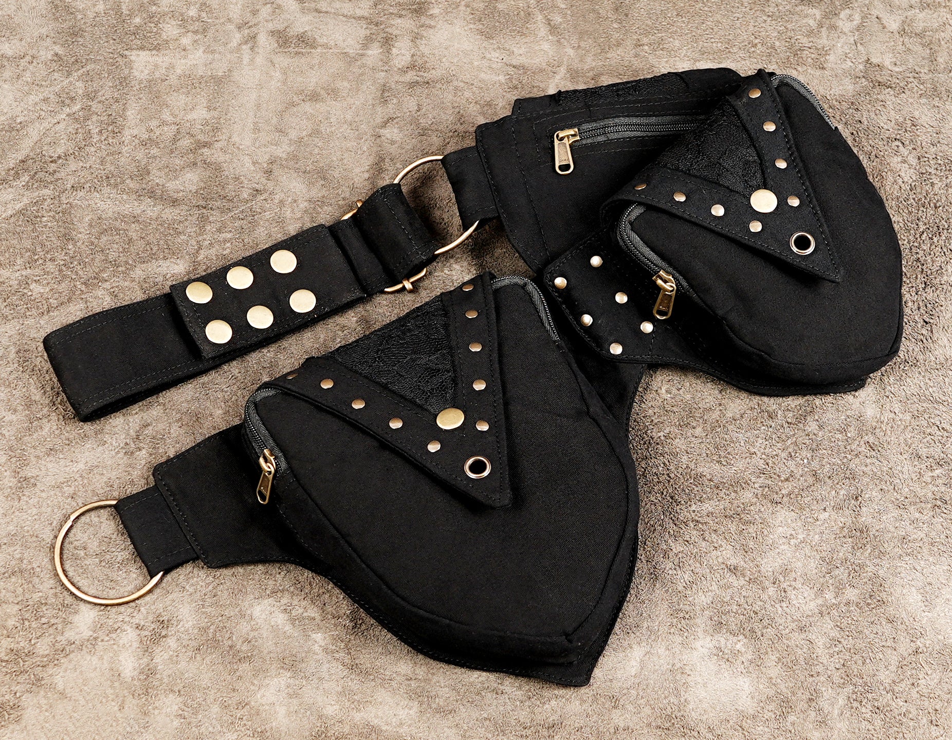 Black utility hip belt with studded flap pockets and adjustable strap
