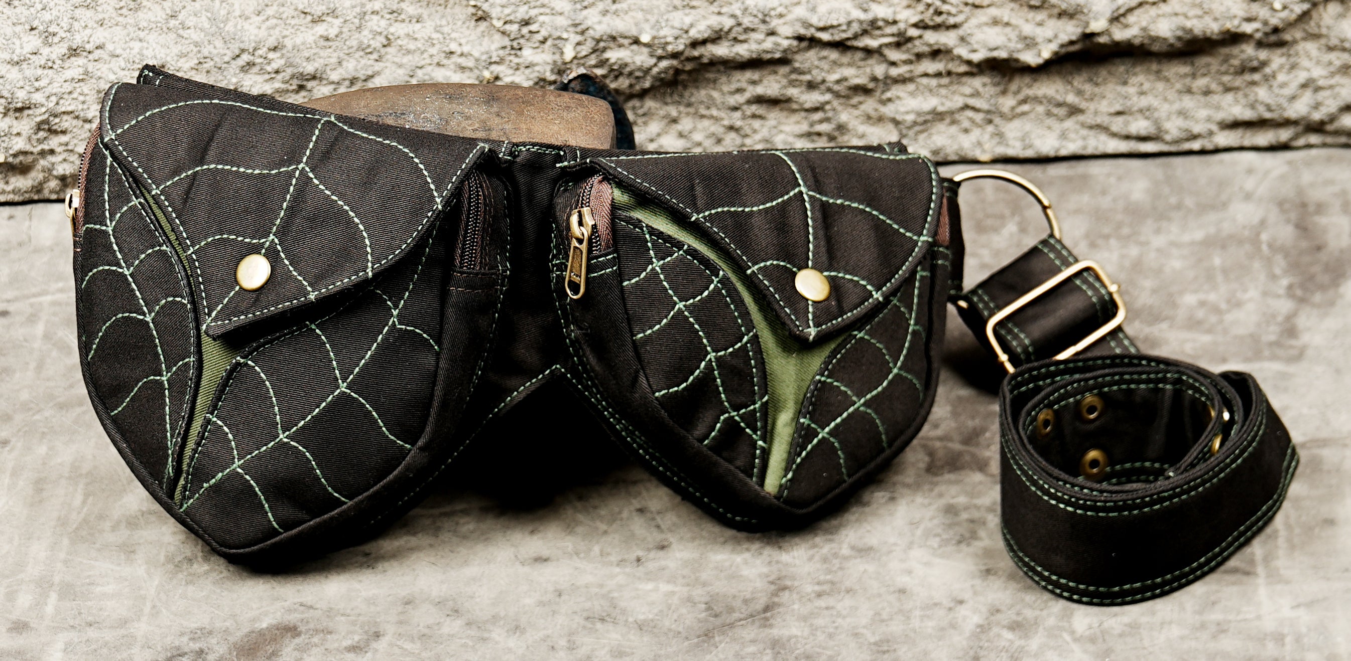 Handcrafted black cotton pocket belt with shield-shaped pouches and green web stitching
