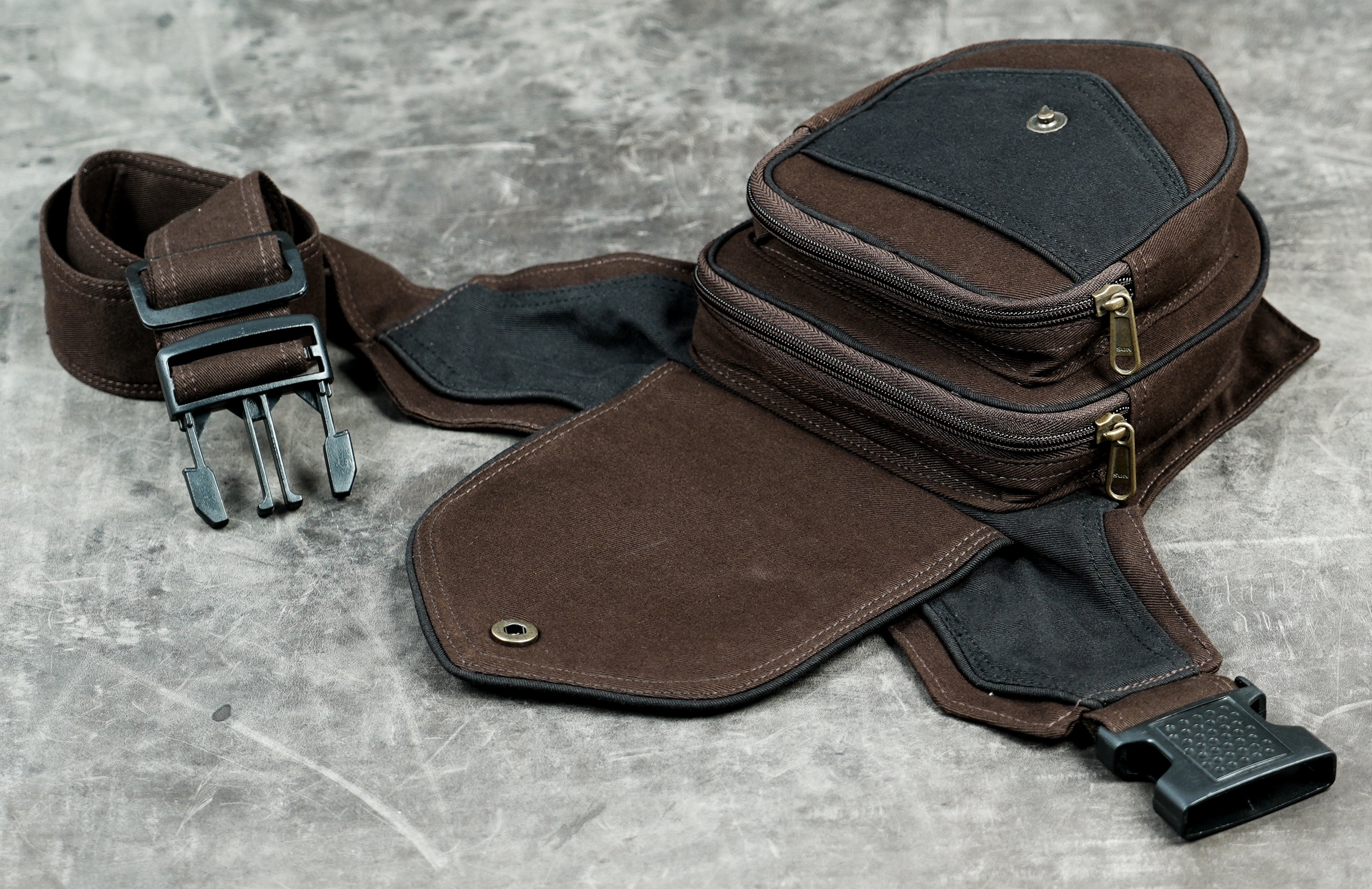 Adjustable brown cotton bum bag with black accent panel flat lay