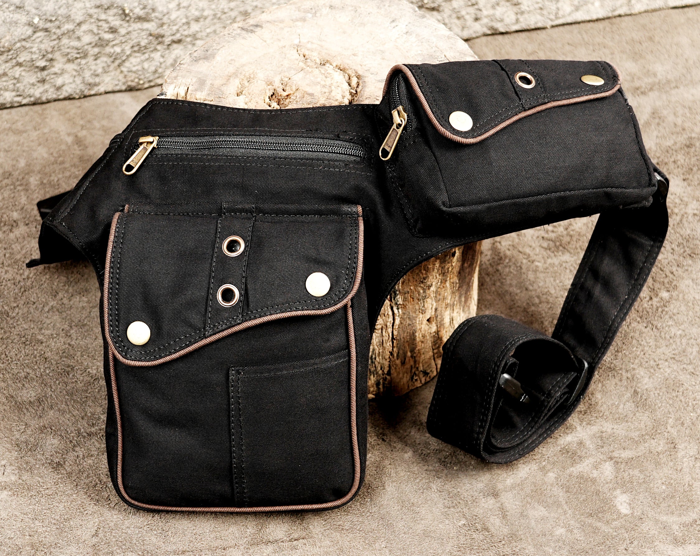 Black canvas belt bag with brown trim and antique brass hardware