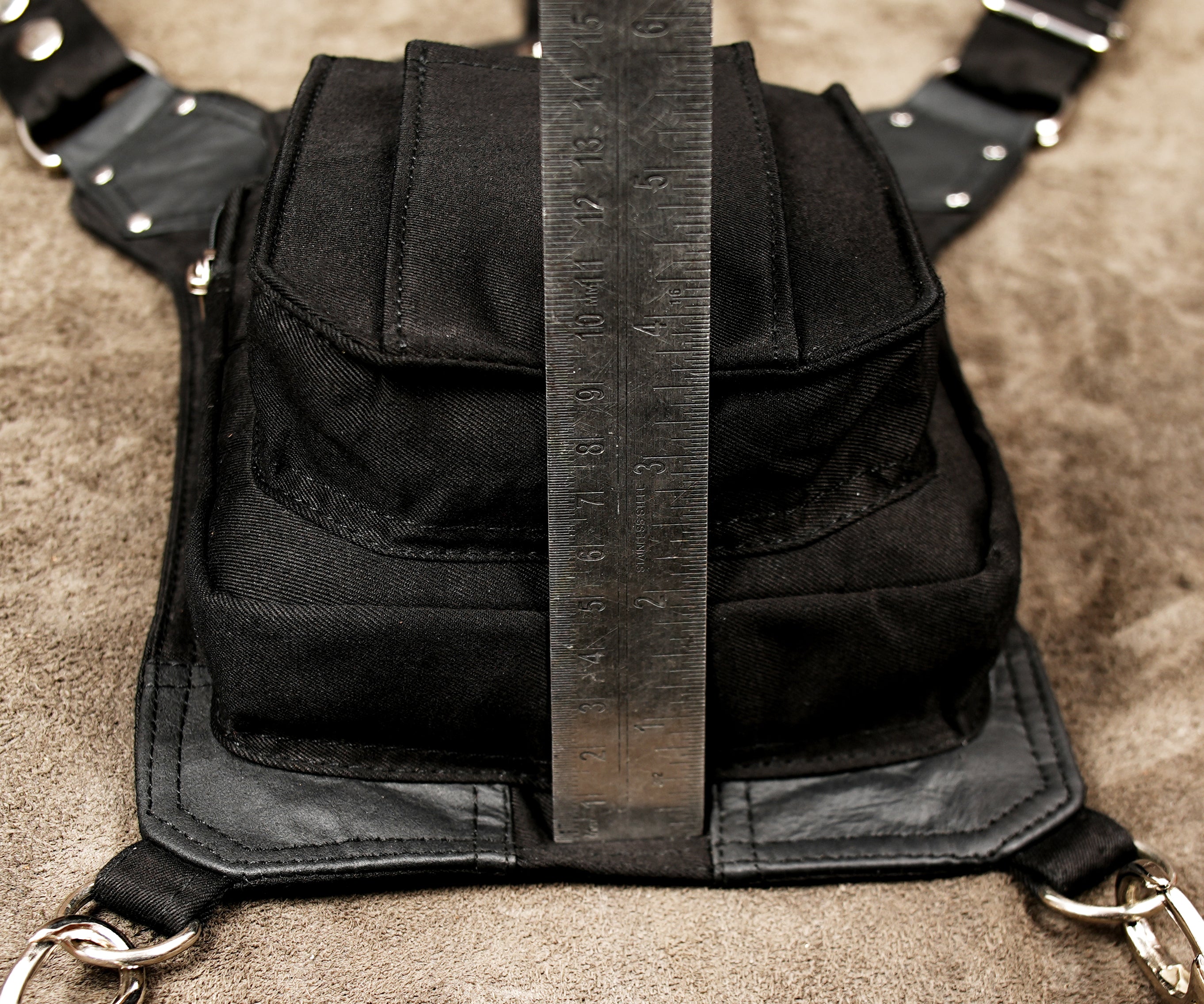 Black waist belt holster bag with front flap and zip closure