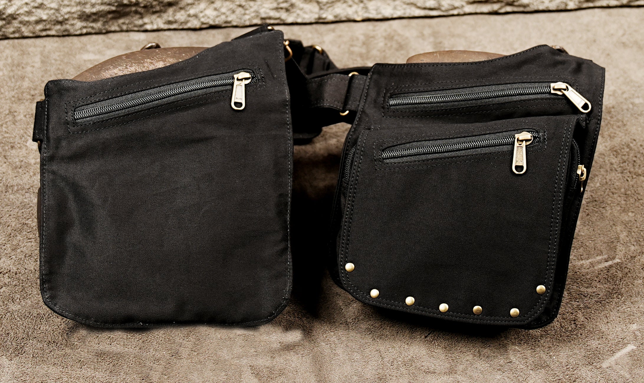 Black cotton holster bag laid flat showing harness and dual pockets