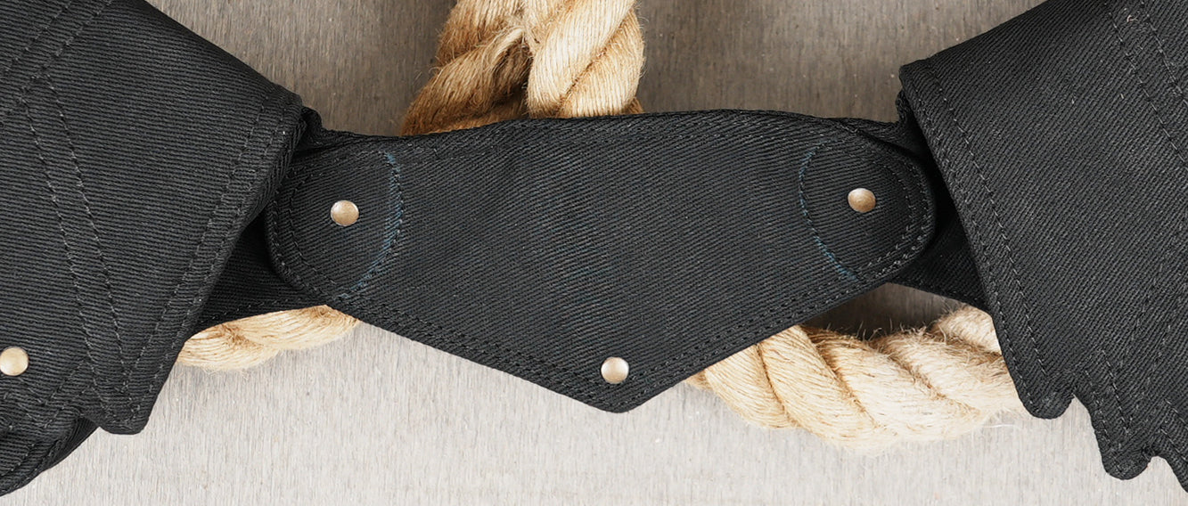 Stylish urban utility belt with multiple pockets and antique-look brass hardware details.