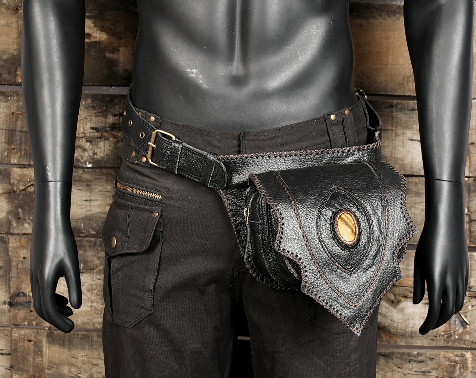 Black leather travel waist pack with decorative stone feature