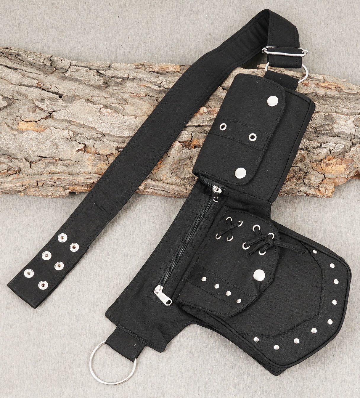 Alternative style hip bumbag featuring large D-rings and studded pockets.