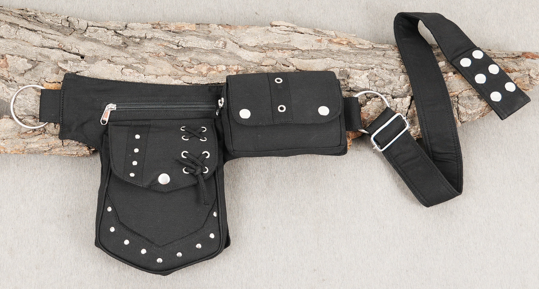 Multi-pouch canvas hip belt with secure zippers and a distinct studded design.