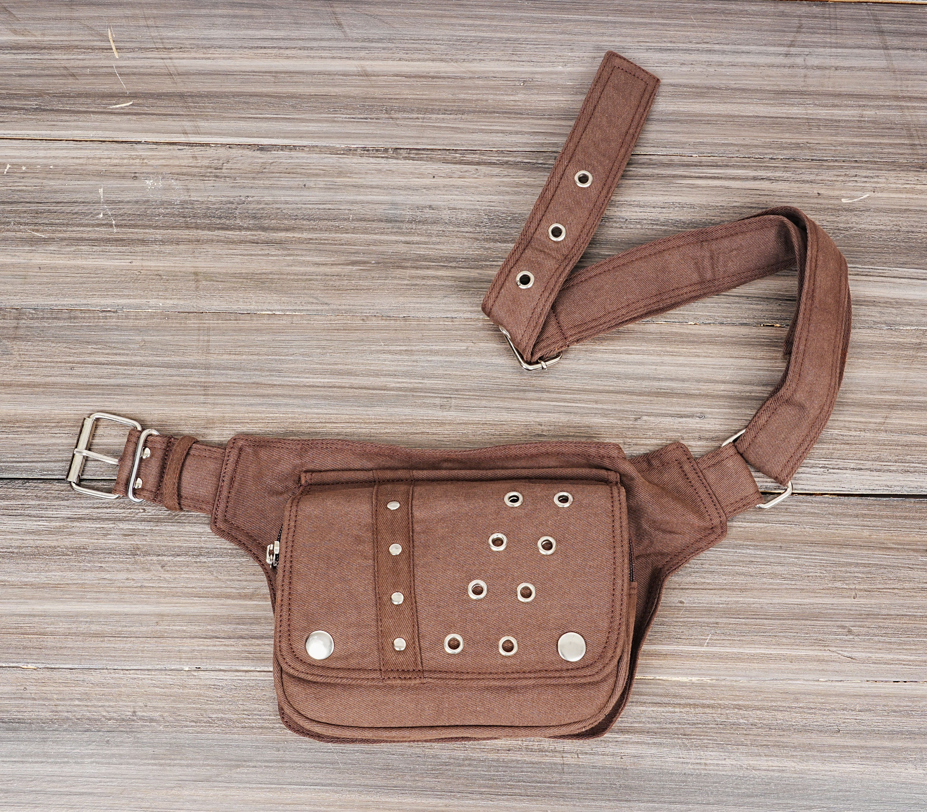 Adjustable fanny pack with stylish metal studs and buckles.