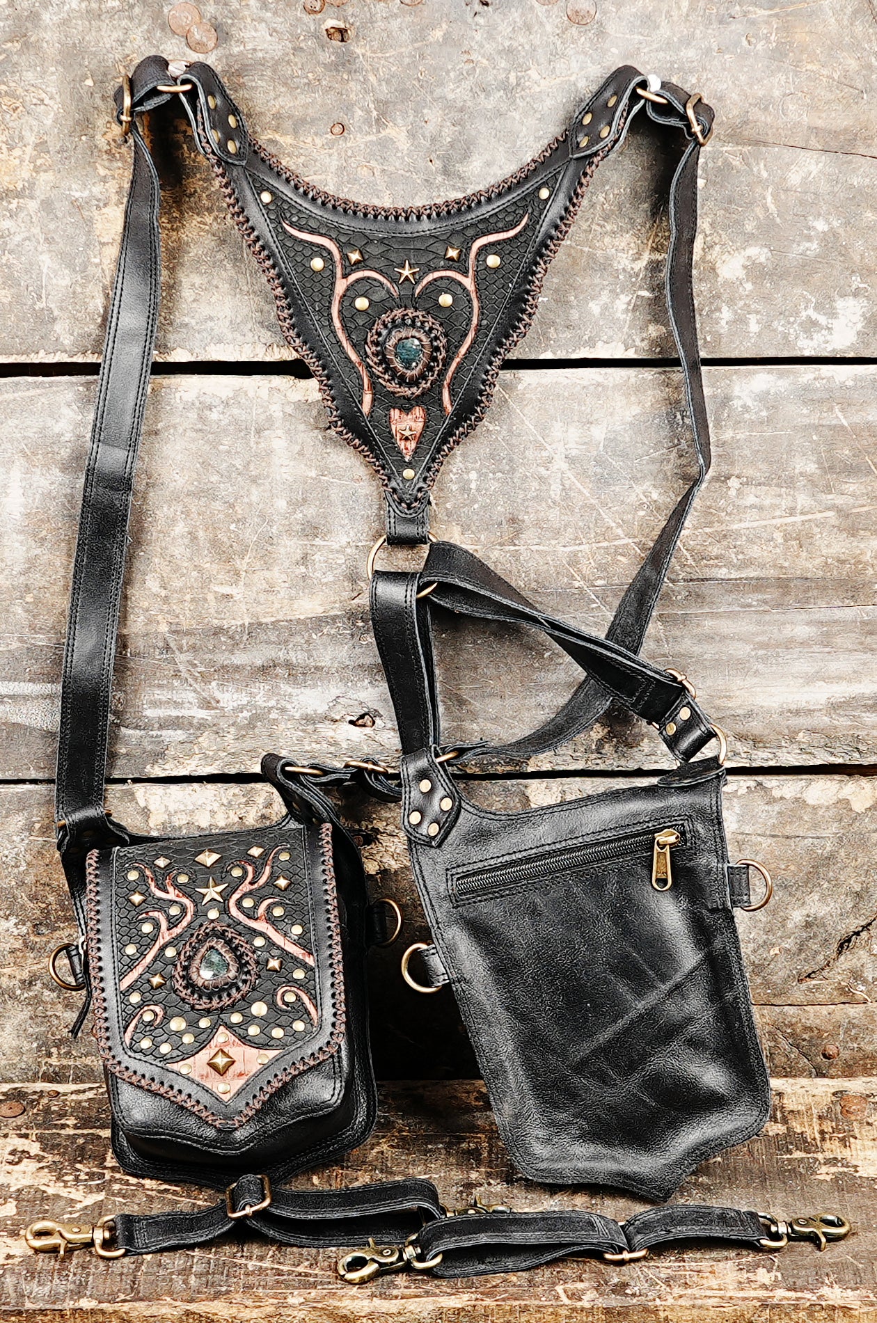 “Steampunk-inspired black leather holster with copper embellishments and gemstones”