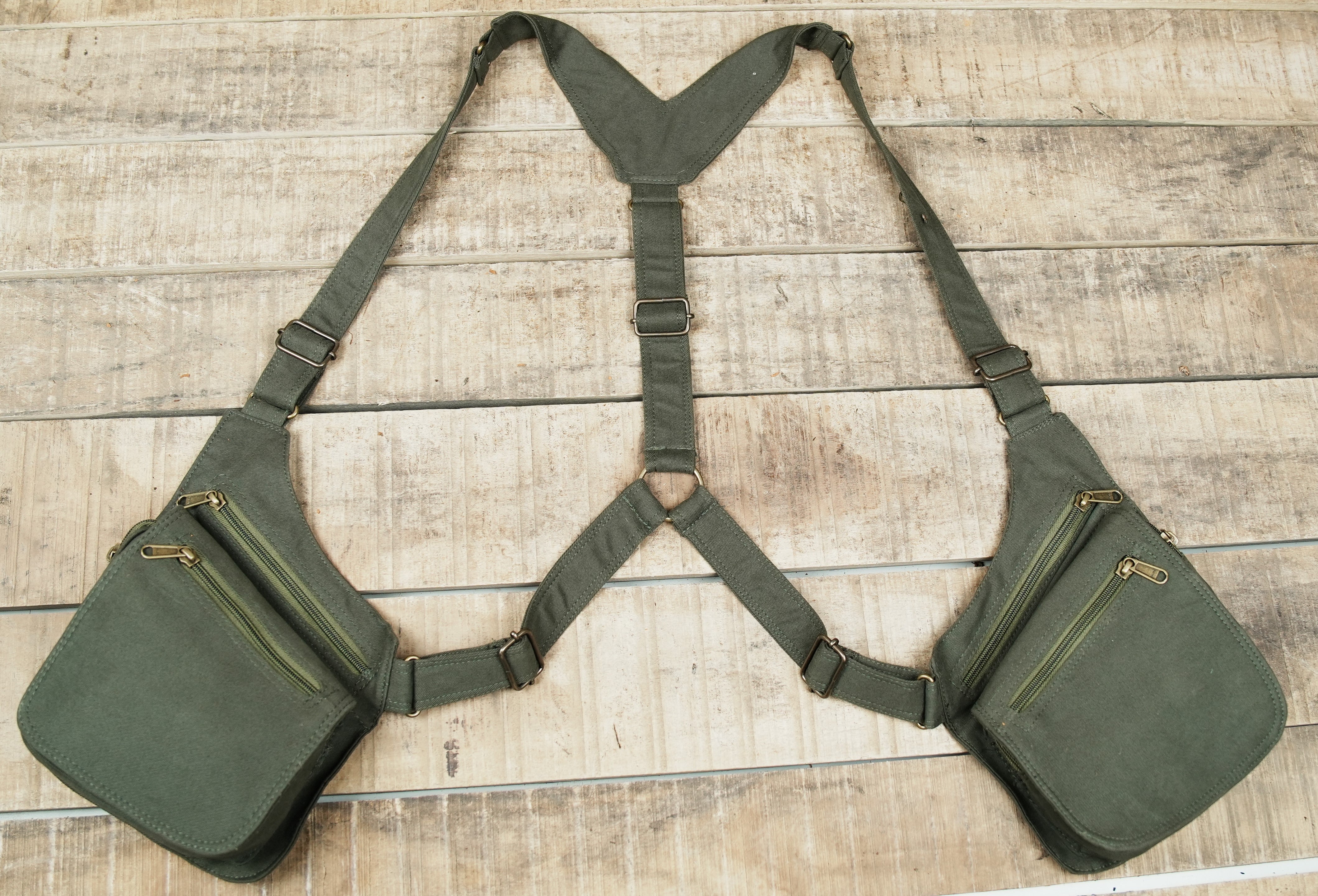 Olive green double shoulder harness bag with dual zippered utility pockets