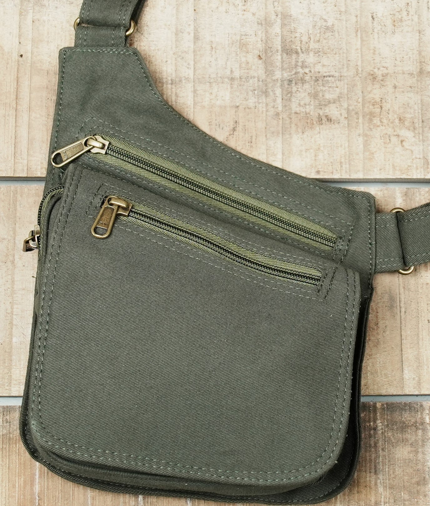 Steampunk style olive canvas body harness featuring bronze hardware accents