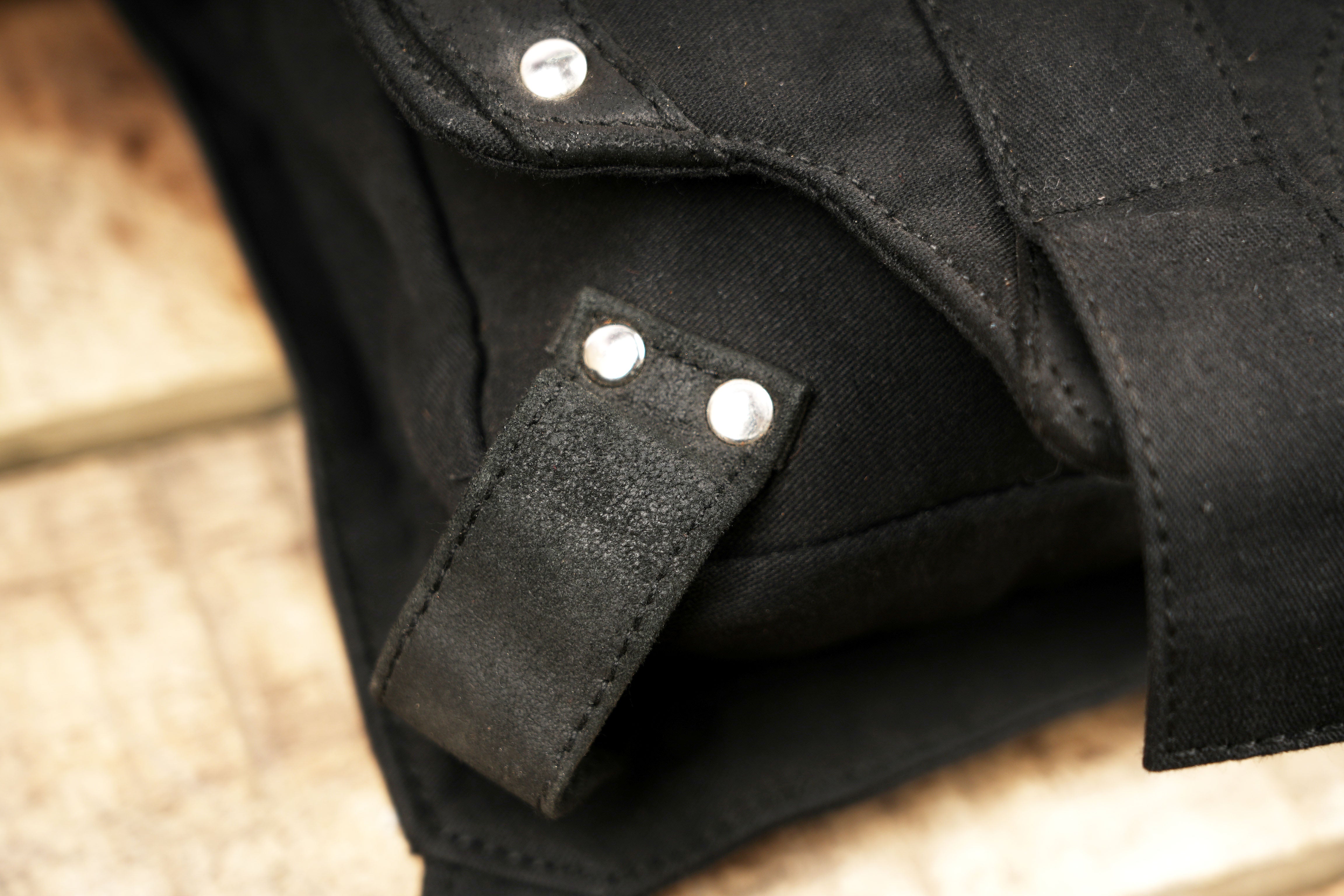Unisex black canvas hip bag with secure leg strap