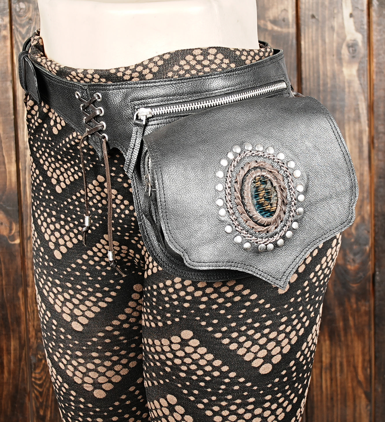 Artistic handmade leather waist bag for travel, featuring gemstone centerpiece.