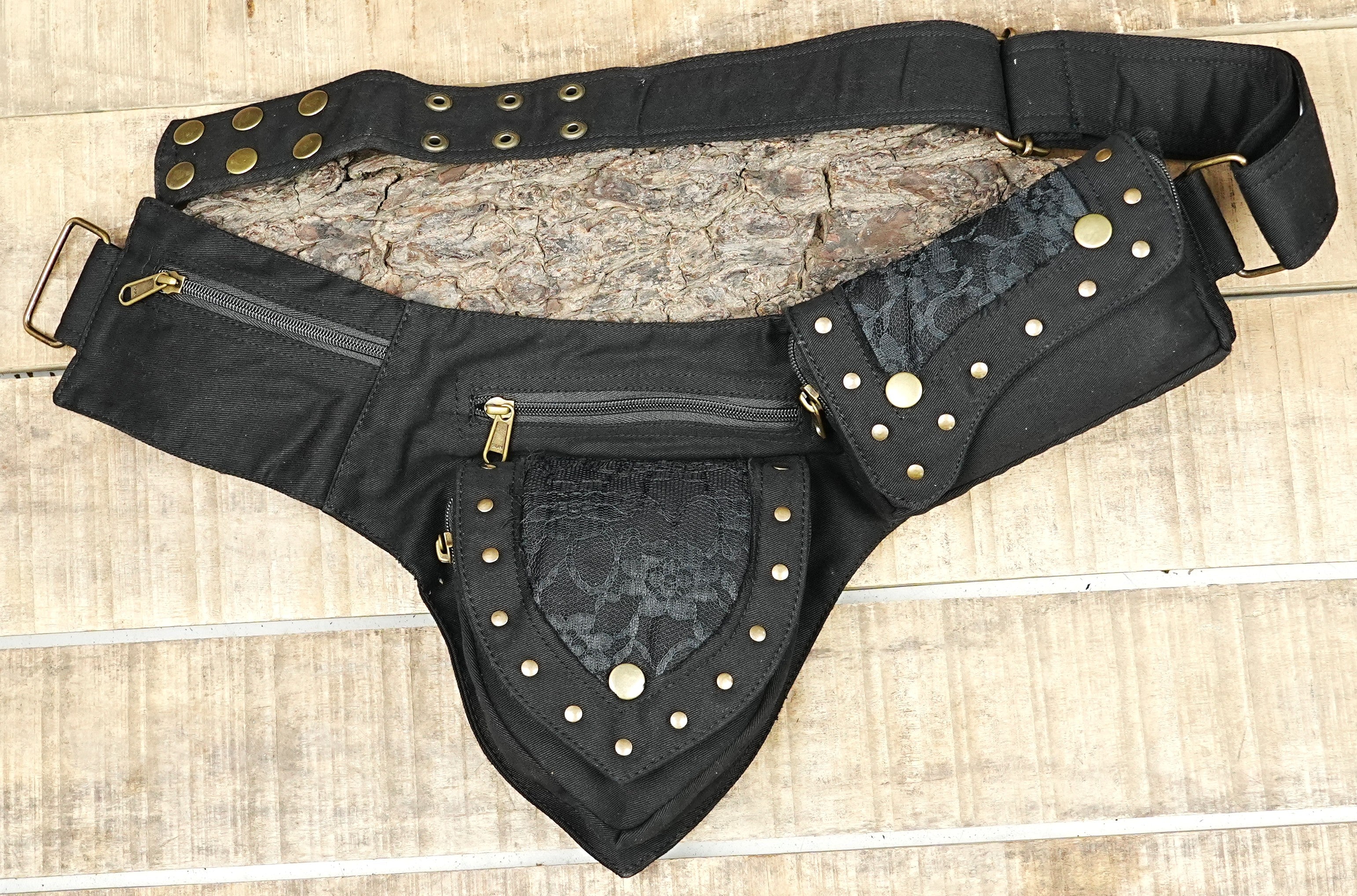 Flat lay of cotton canvas bum bag with brass zipper pulls and eyelet belt